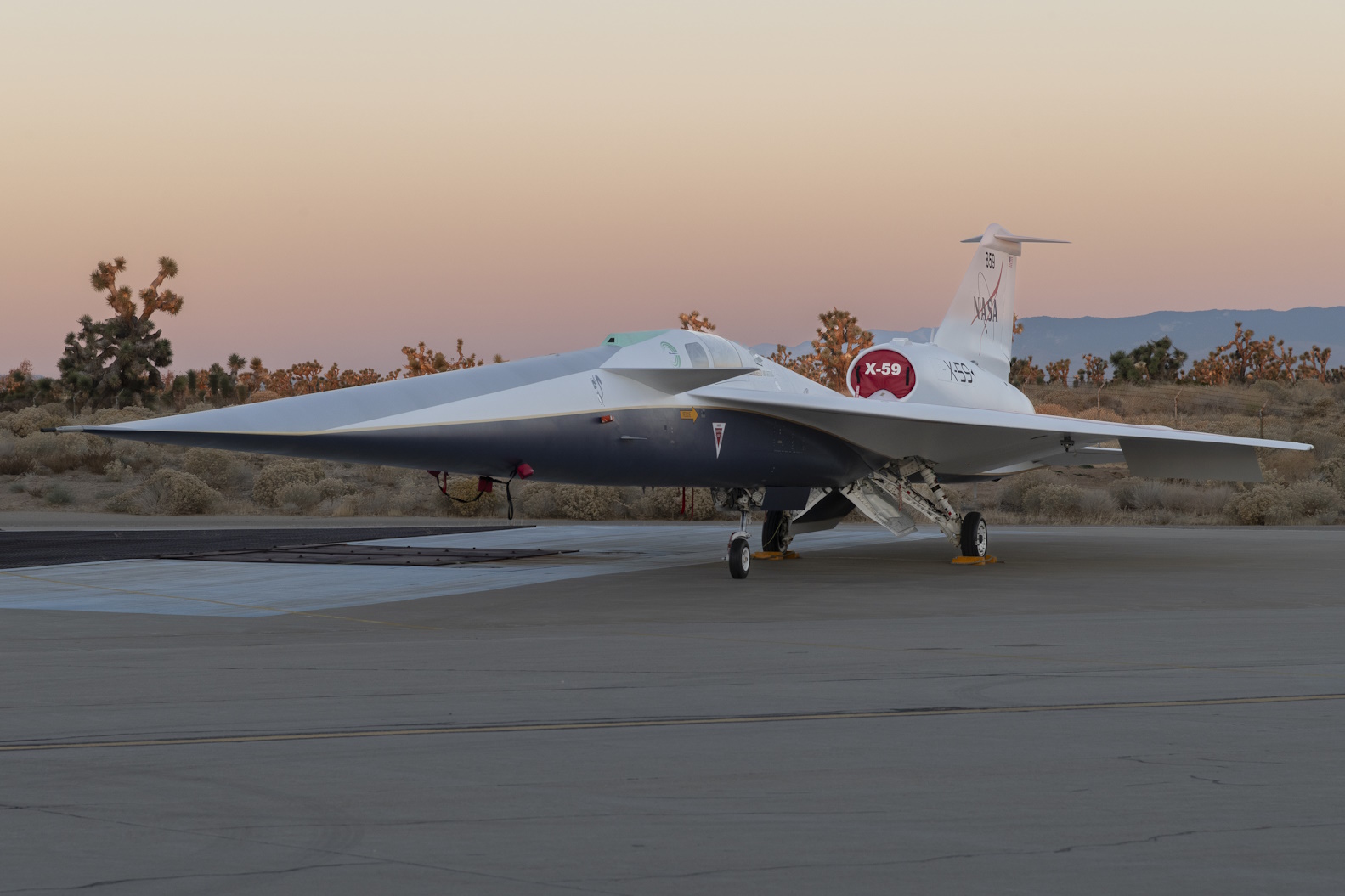NASA’s X-59 quiet supersonic research aircraft sits on the ramp at Lockheed Martin Skunk Works in Palmdale, California, during sunrise.