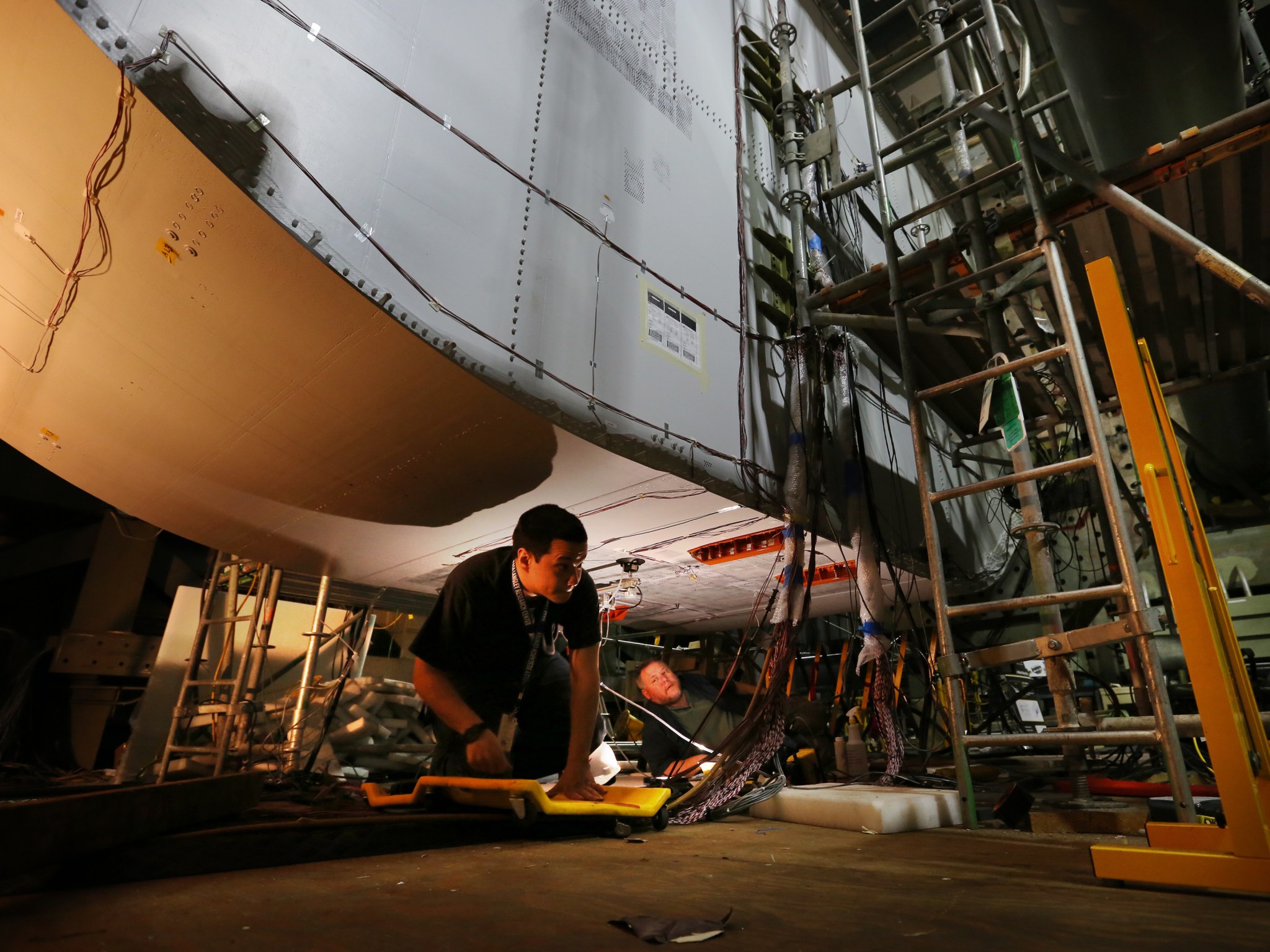 NASA technicians conduct a non-destructive inspection of the keel section of the PRSEUS multi-bay box inside the COLTS.