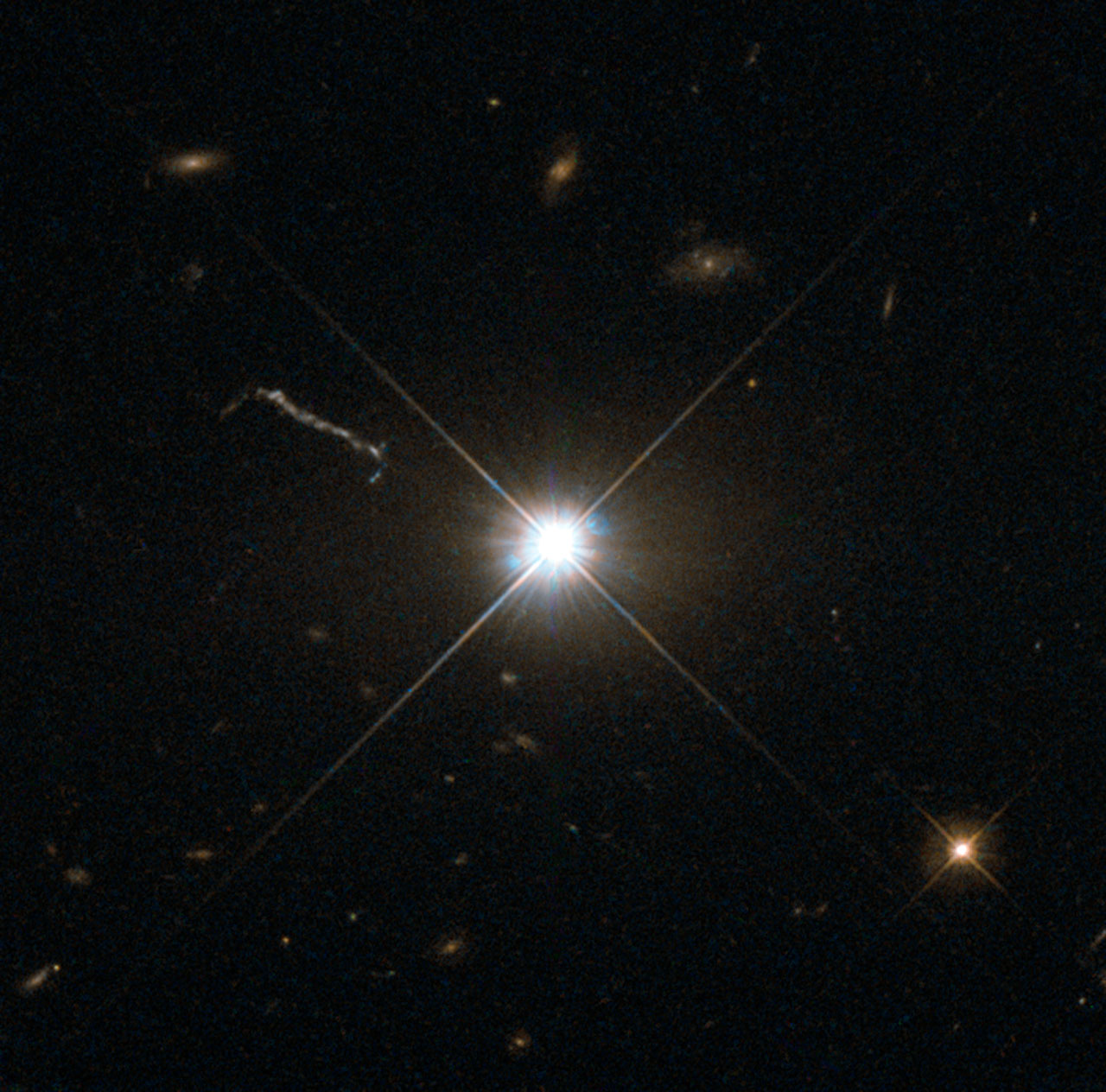 A picture of a far away quasar, shown as a bright point of light in the center of the picture.