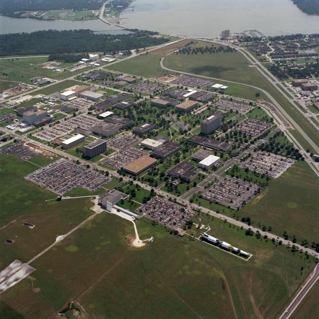 An aerial view of the complete Johnson Space Center facility. Part of Clear Lake can be seen at the top of the view.