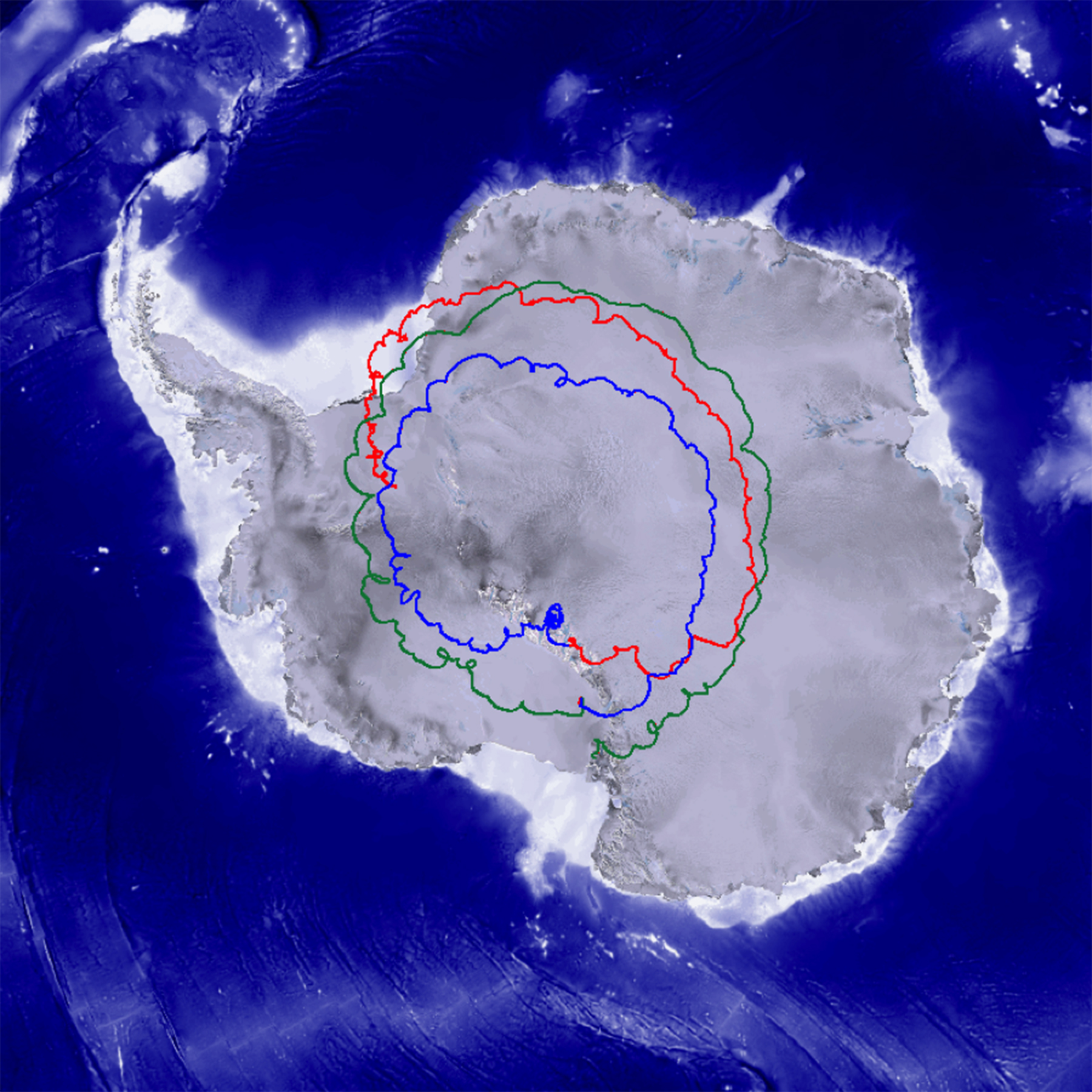 A satellite image of Antartica highlighted with three colored lines shows the groundtrack of the Super-TIGER mission, which flew from Antarctica during the 2012/2013 campaign. The tracks are vaguely circular and travel around the center of the apostrophe-shaped continent, which is white against a blue ocean background.