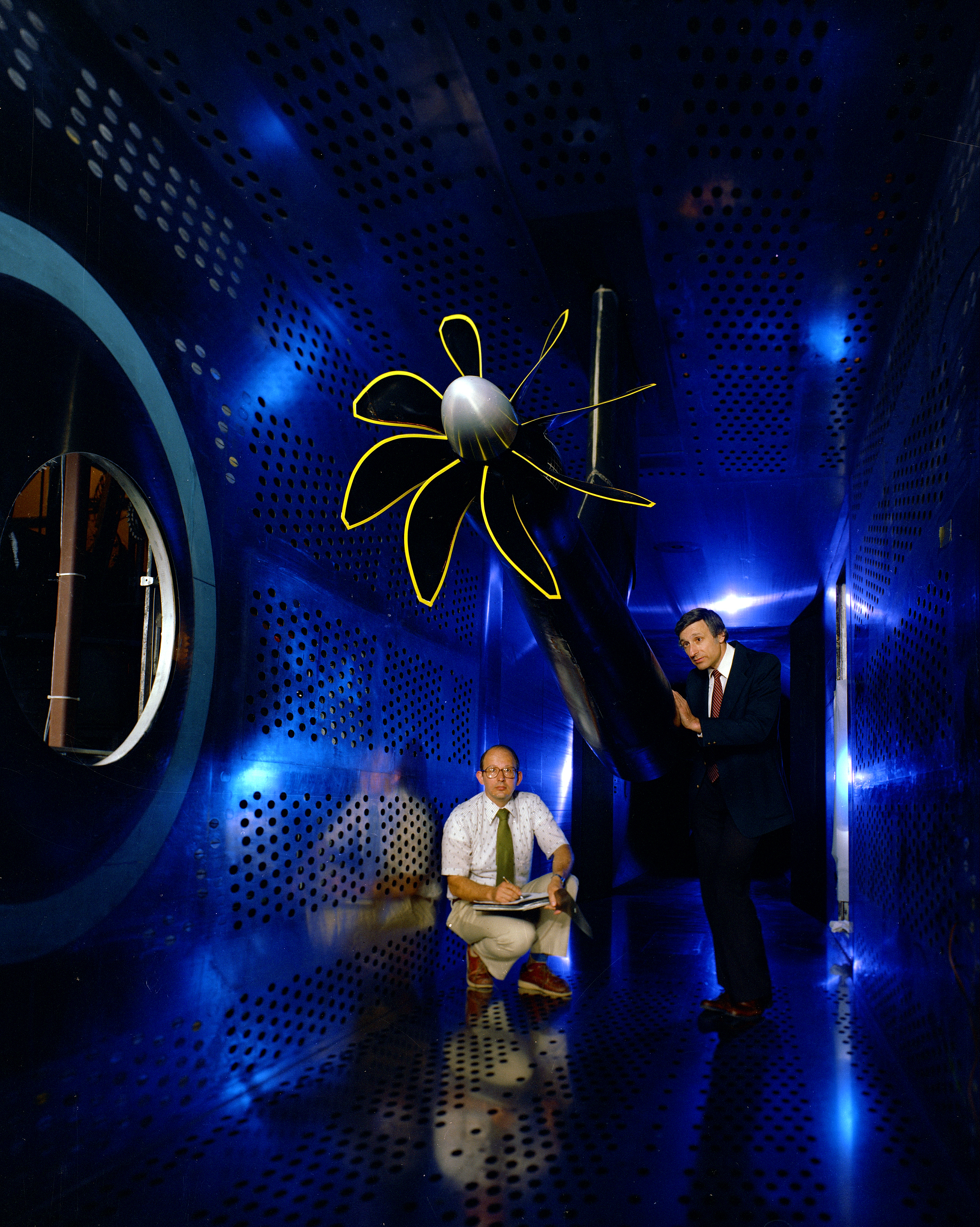 Two men inside the 8x6 Supersonic Wind Tunnerl inspecting the SR-7A Turbosprop.