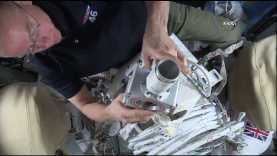 Tim Kopra readies equipment for Friday's spacewalk