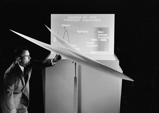 Ames aeronautical engineer Lynn Hunton posing with a display model of the Katzen arrow wing in August 1958. 