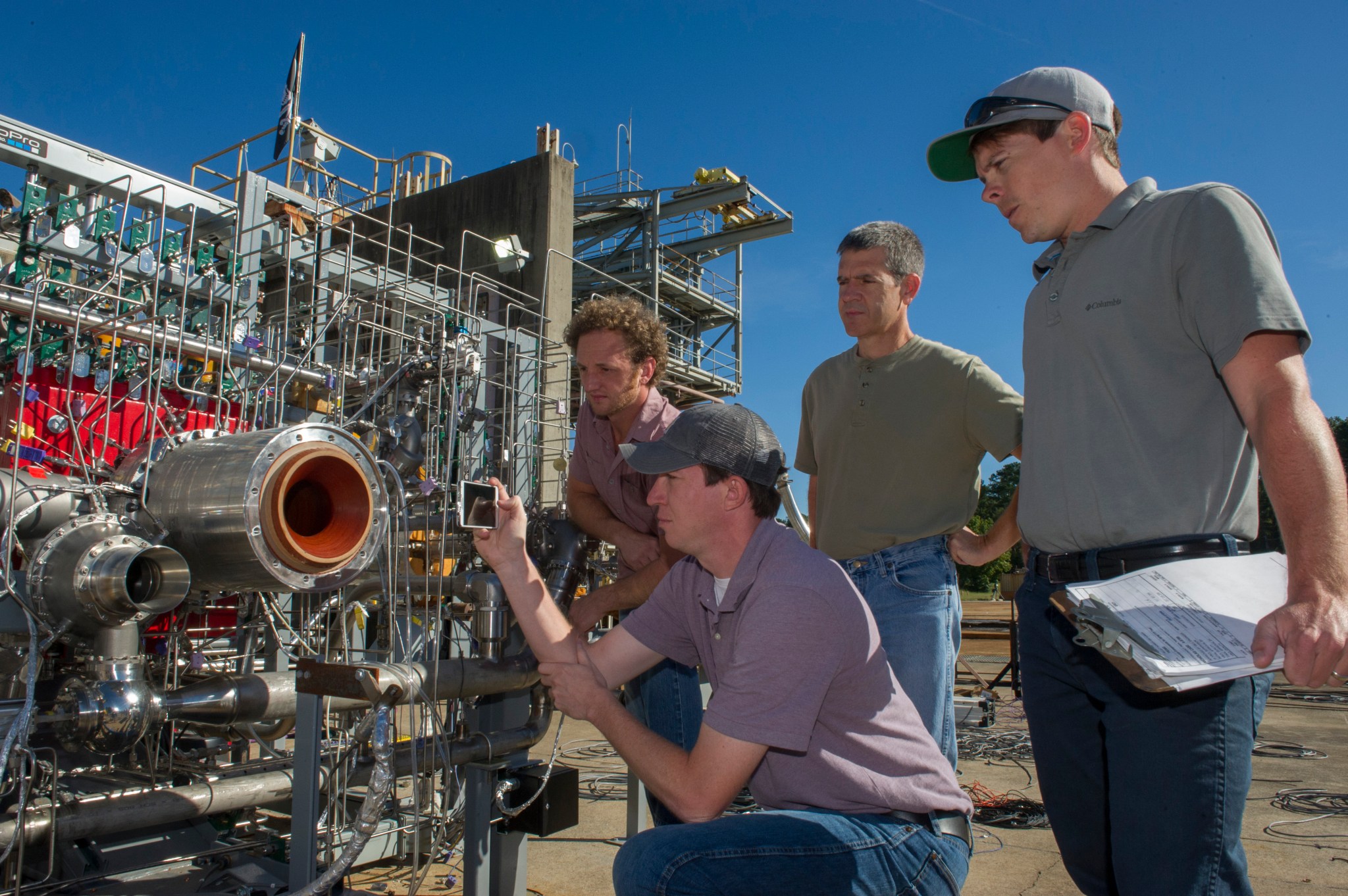 Engineers prepare a 3-D printed breadboard engine made up of 75 percent of the parts needed to build a rocket engine for a test.