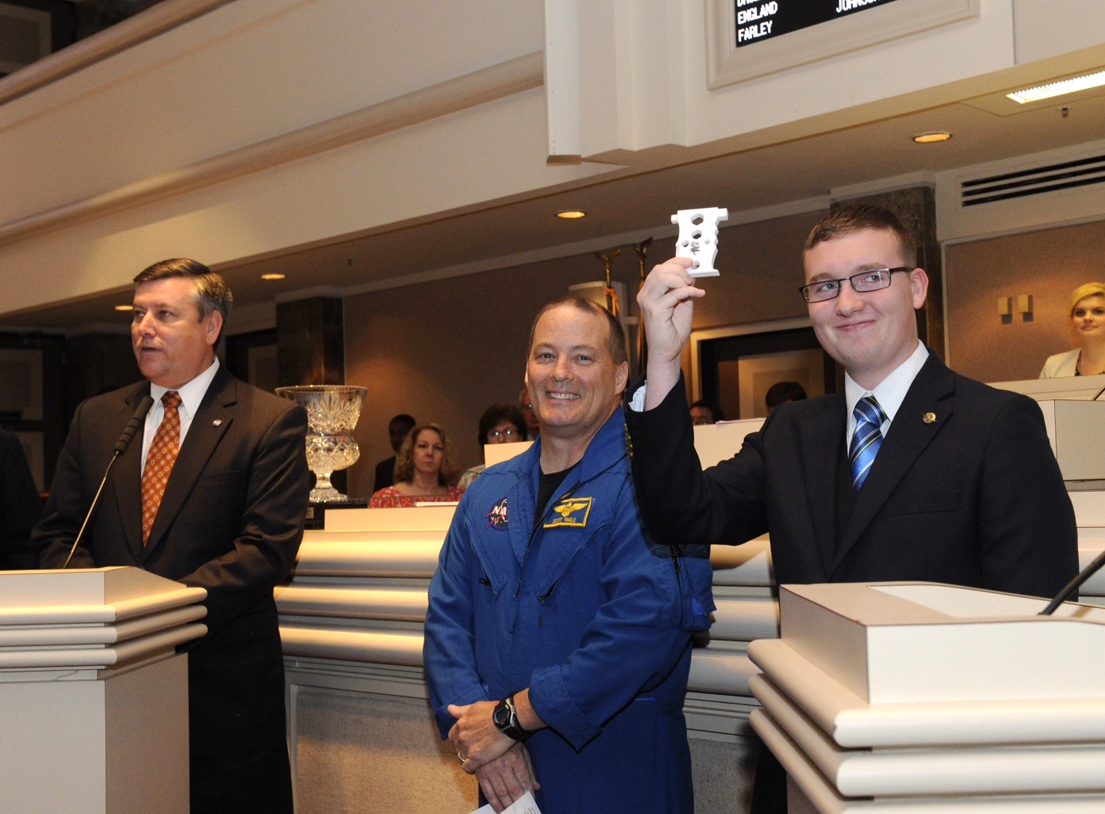 High school senior Robert Hillan of Enterprise, Alabama, shows the tool he designed for astronauts.