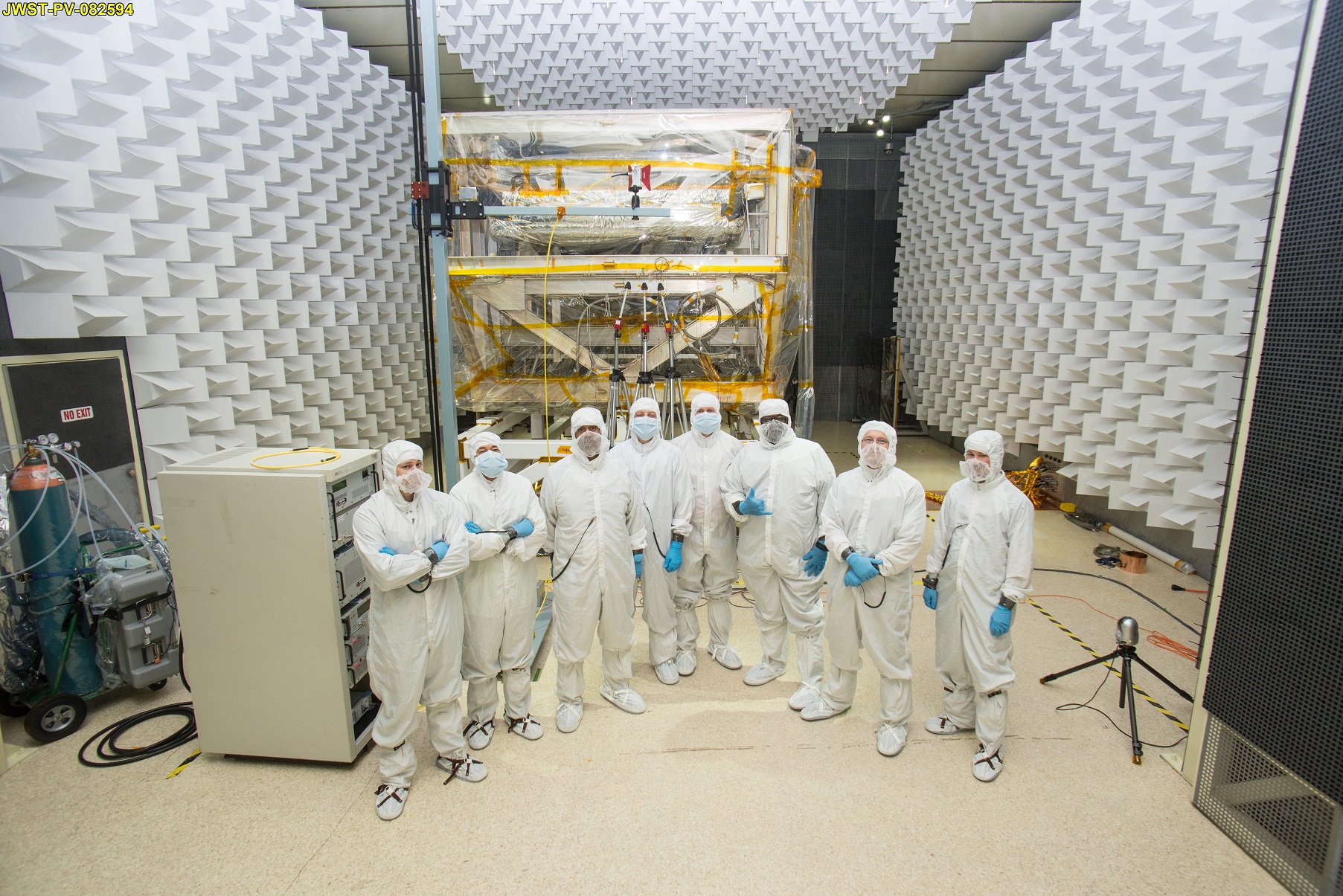 A team of engineers in special clean room suits at NASA Goddard.