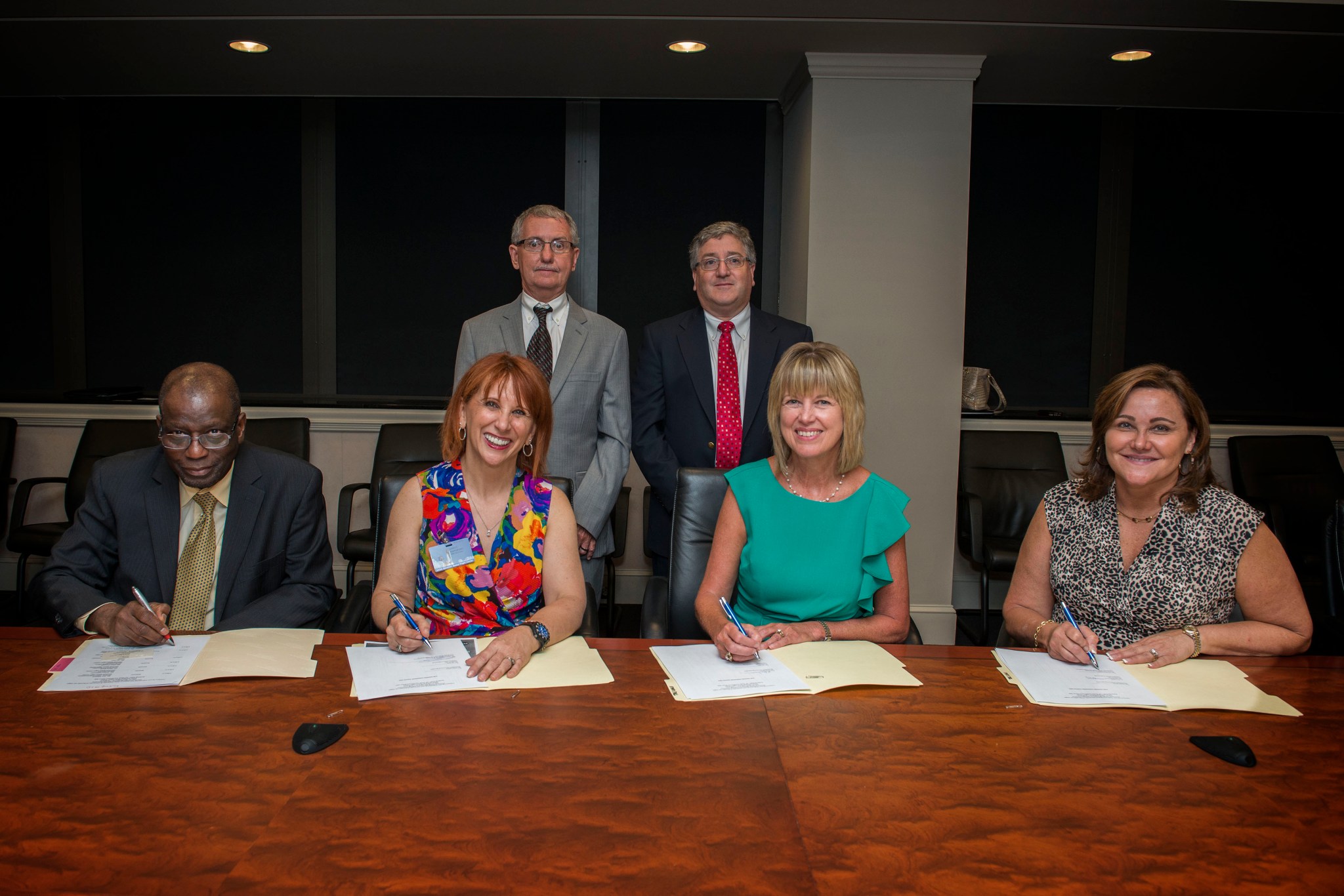 Photo signing mentor-protégé agreements on July 27.