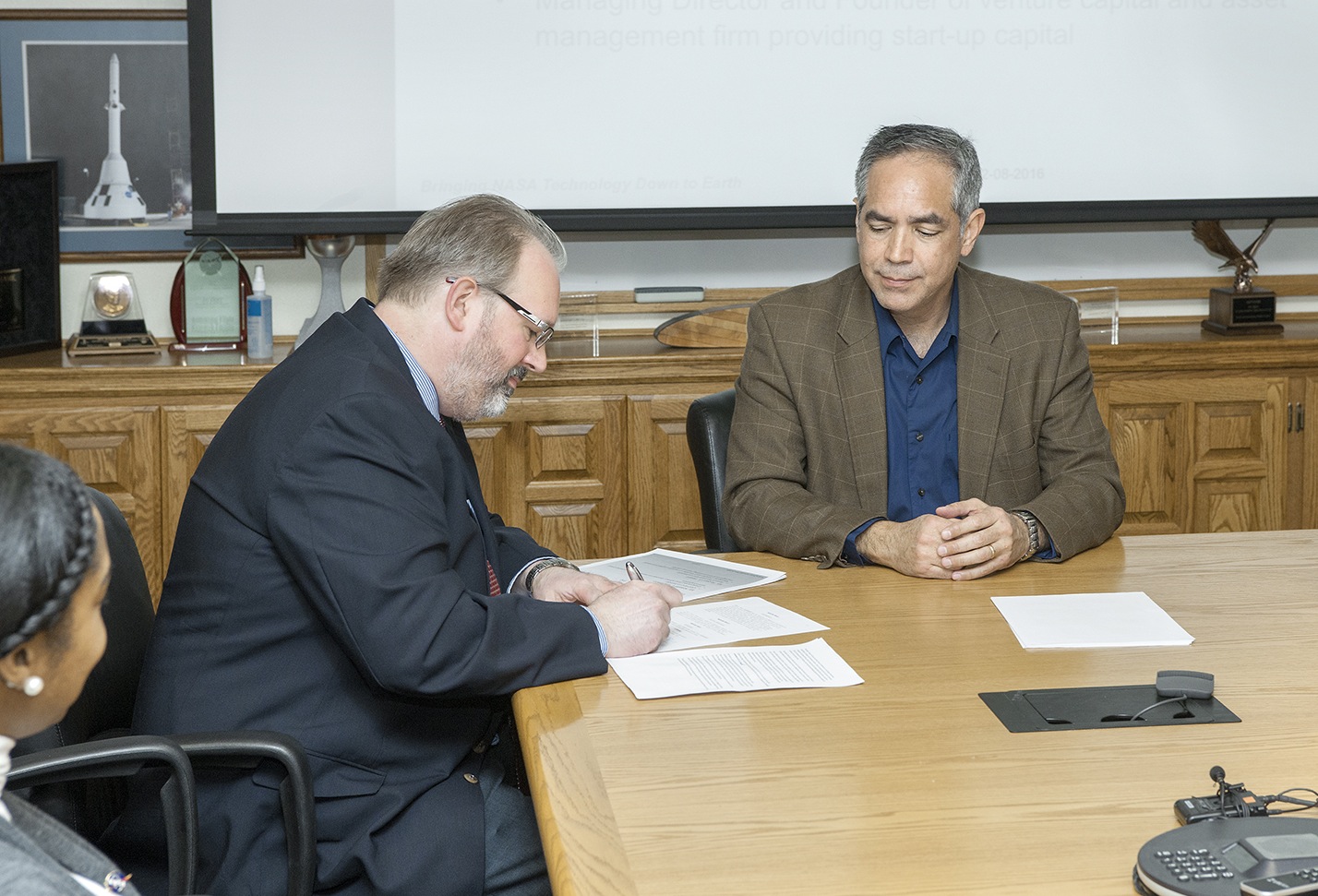 Kraettli Epperson and David McBride sign an agreement to commercialize aircraft tracking system for unmanned aircraft.