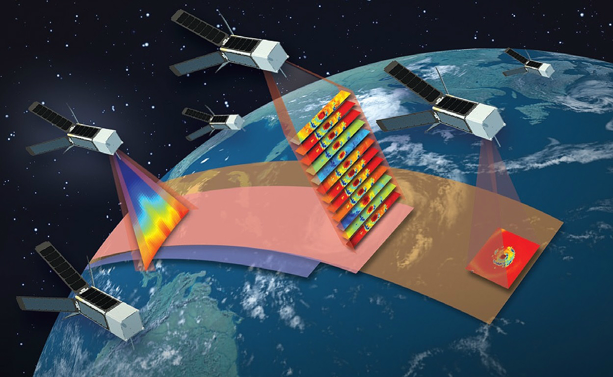 An illustration of a group of small satellites in orbit above and imaging Earth. The satellites look like long rectangular cubes, with solar panels extended like fins out the back. Three satellites near the center of the image have pink cones representing beams reaching down to Earth's surface, each with different types of rainbow-colored images representing the types of data they will collect. Earth below looks like a deep blue sphere with green land masses and white swirling clouds, and space is black in the background.