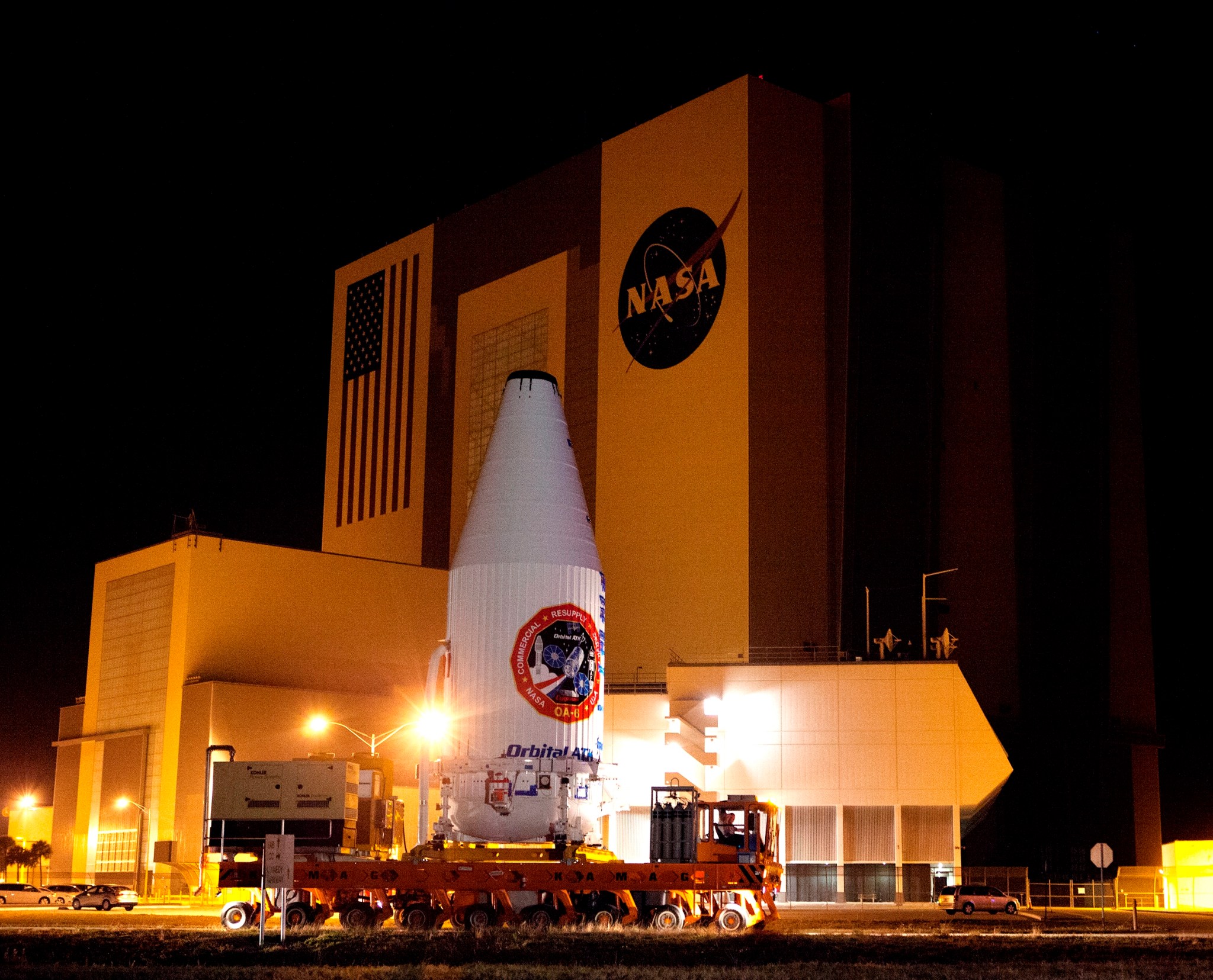 Encapsulated Cygnus Moves Past Vehicle Assembly Building
