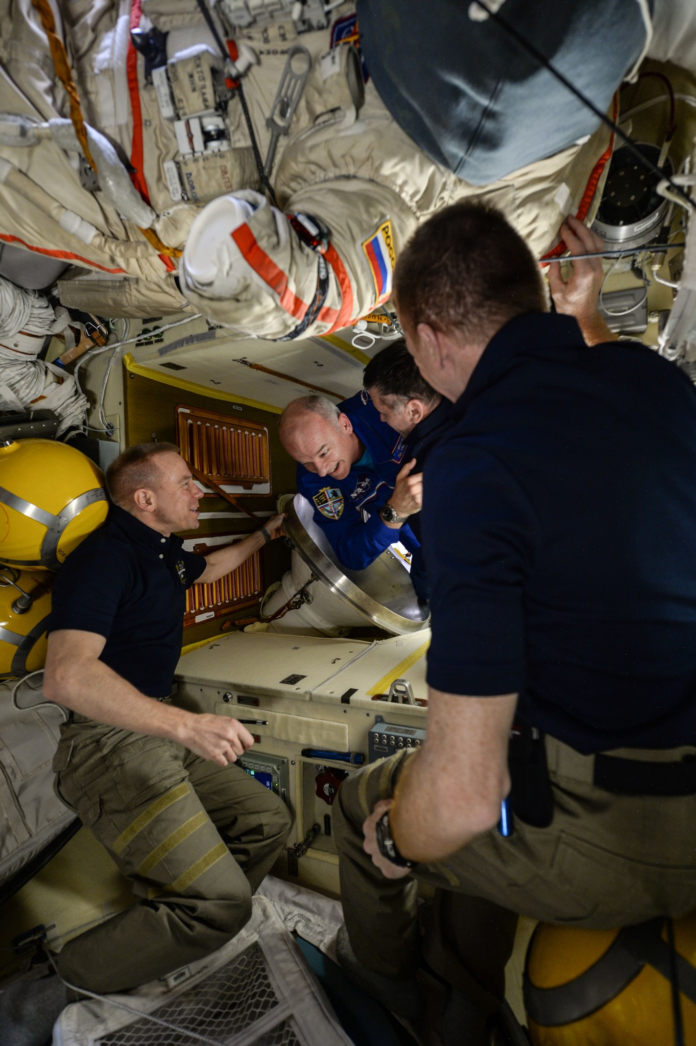 NASA astronaut Jeff Williams, center, is welcomed to the International Space Station upon his arrival March 19. 