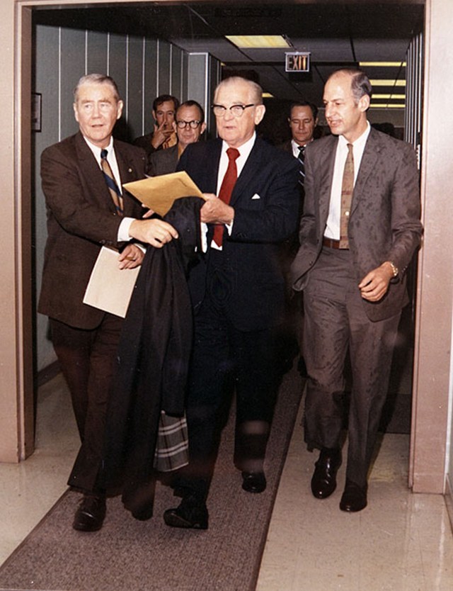 Jackson Balch (left) hurries with Sen. John C. Stennis (center) and NASA Acting Administrator George Low