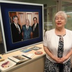 Wealtha Fortune Weaver of Ocean Springs stands next to a photo of her father, Capt. William C. Fortune