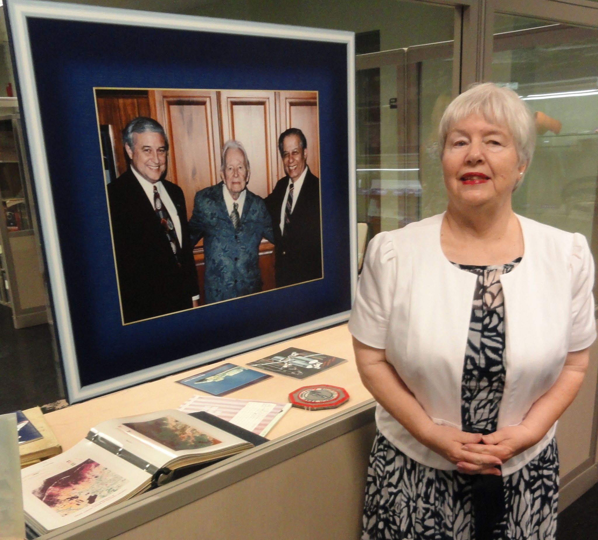 Wealtha Fortune Weaver of Ocean Springs stands next to a photo of her father, Capt. William C. Fortune