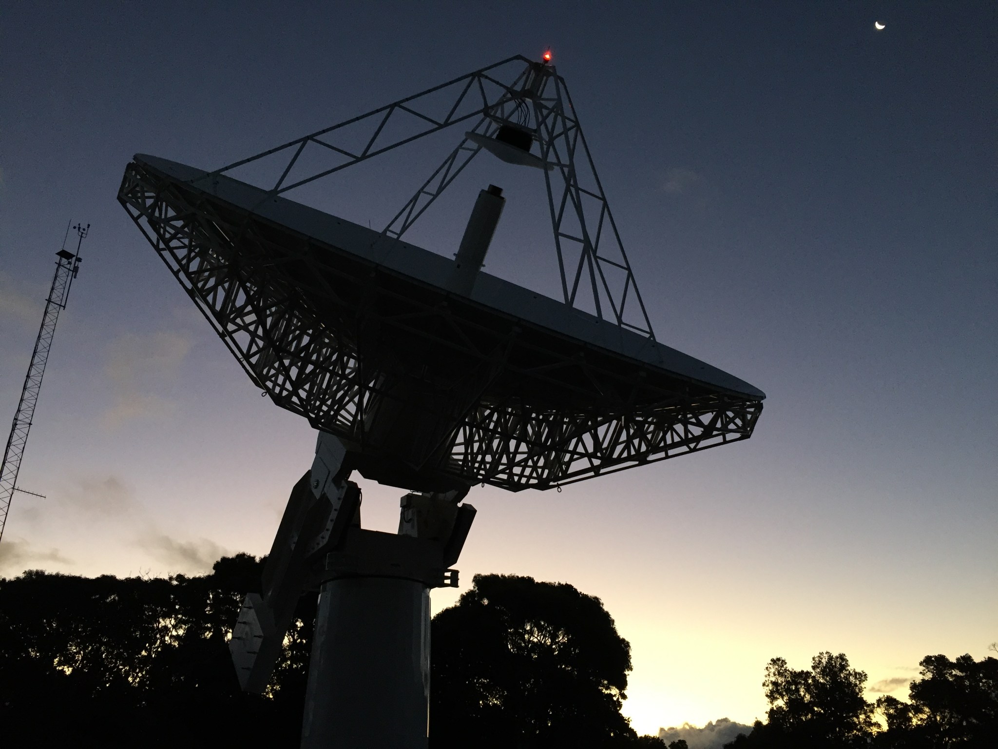 sillhouette of satellite dish at dusk