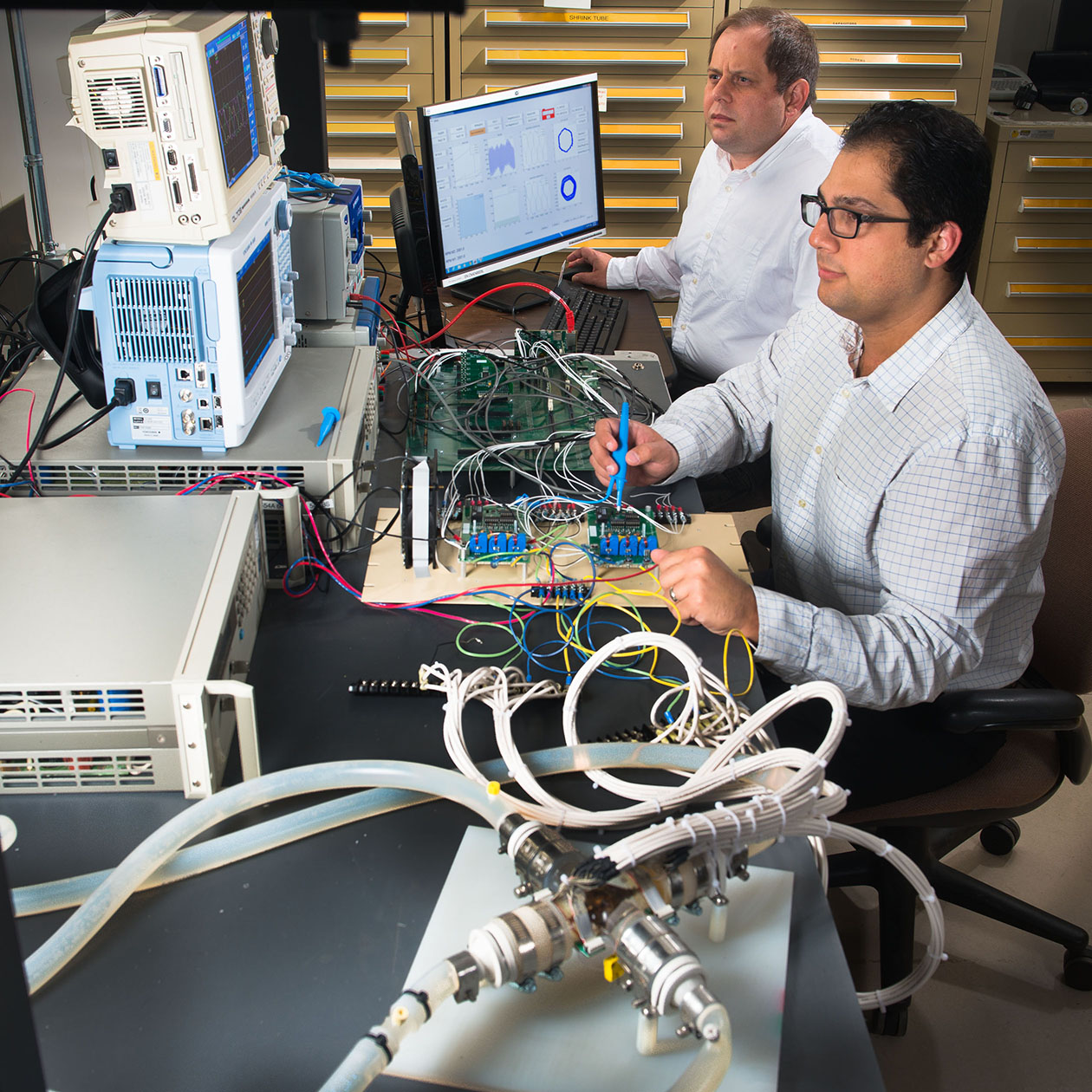 NASA Glenn engineers David Avanesian and Peter Kascak test a flywheel motor designed for a heart pump.