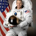 Astronaut Andrew Feustel wearing a spacesuit posing for his official NASA portrait.