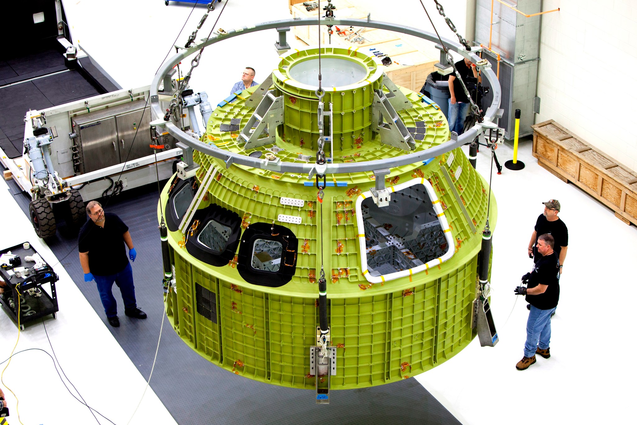 The Orion EM-1 pressure module hangs from the ceiling at Kennedy Space Center's Neil Armstrong Operations and Checkout Building