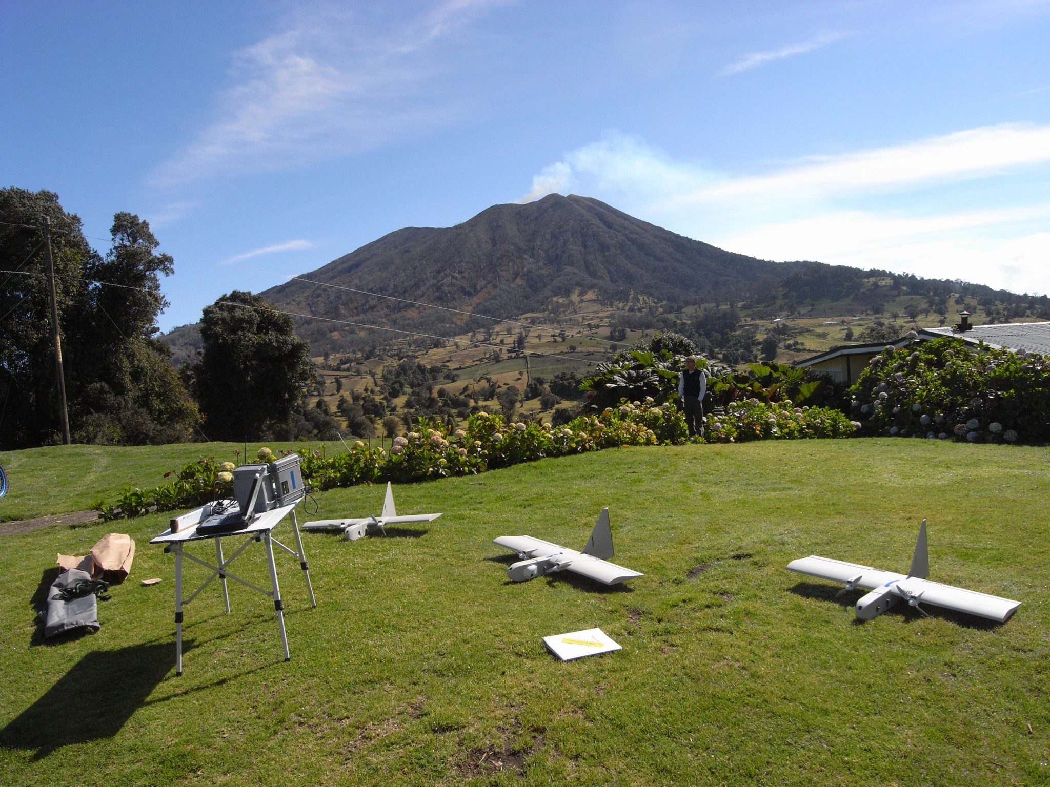 Green grass with series of small unmanned aircraft on ground