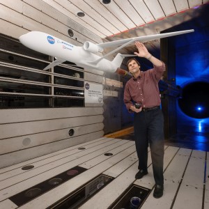 Image of a man looking at a model of Truss Braced Wing test in the 11-by 11-foot test section.