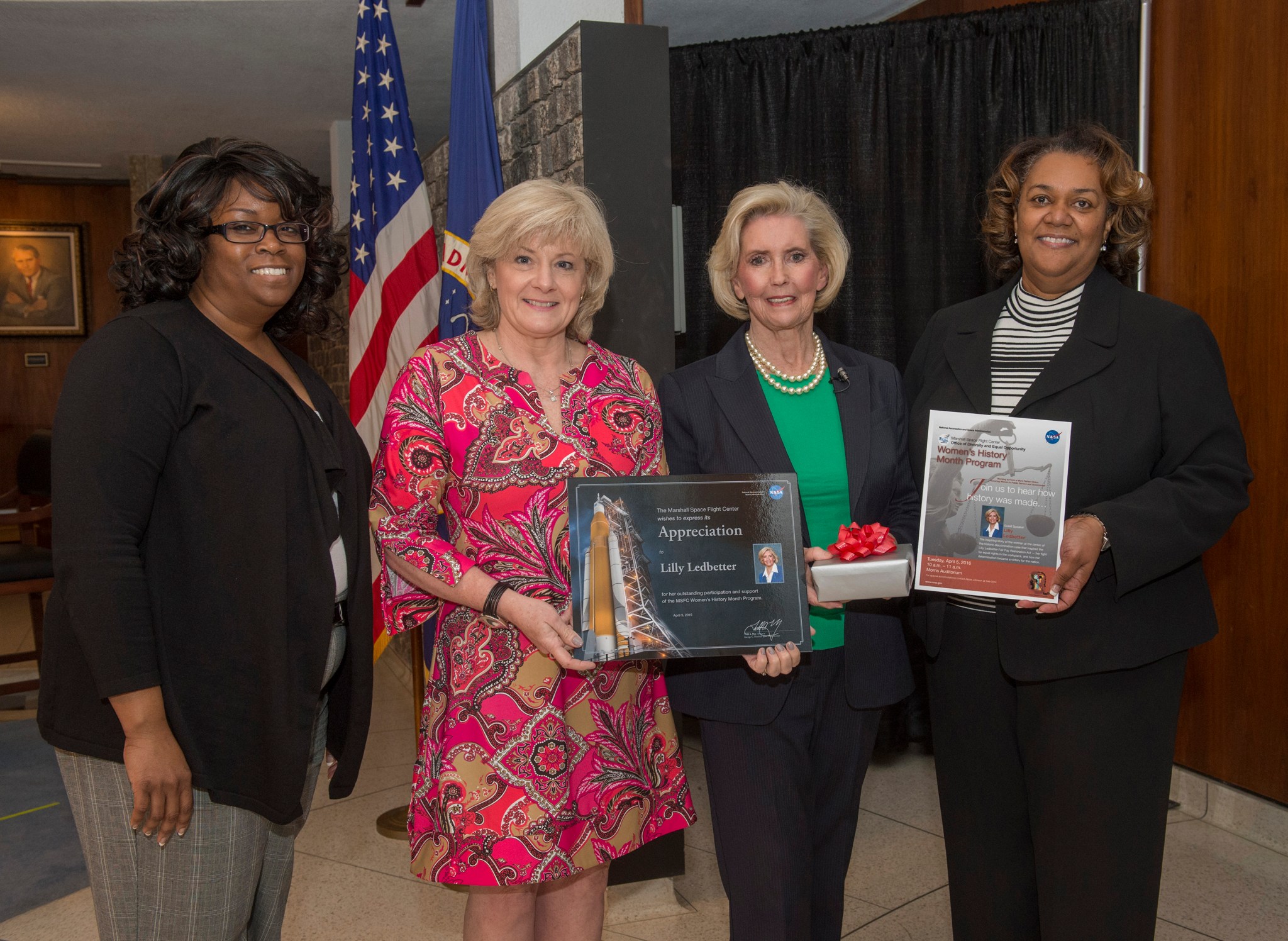 Women's equality activist Lilly Ledbetter, second from right, is presented with a certificate of appreciation by Jody Singer.