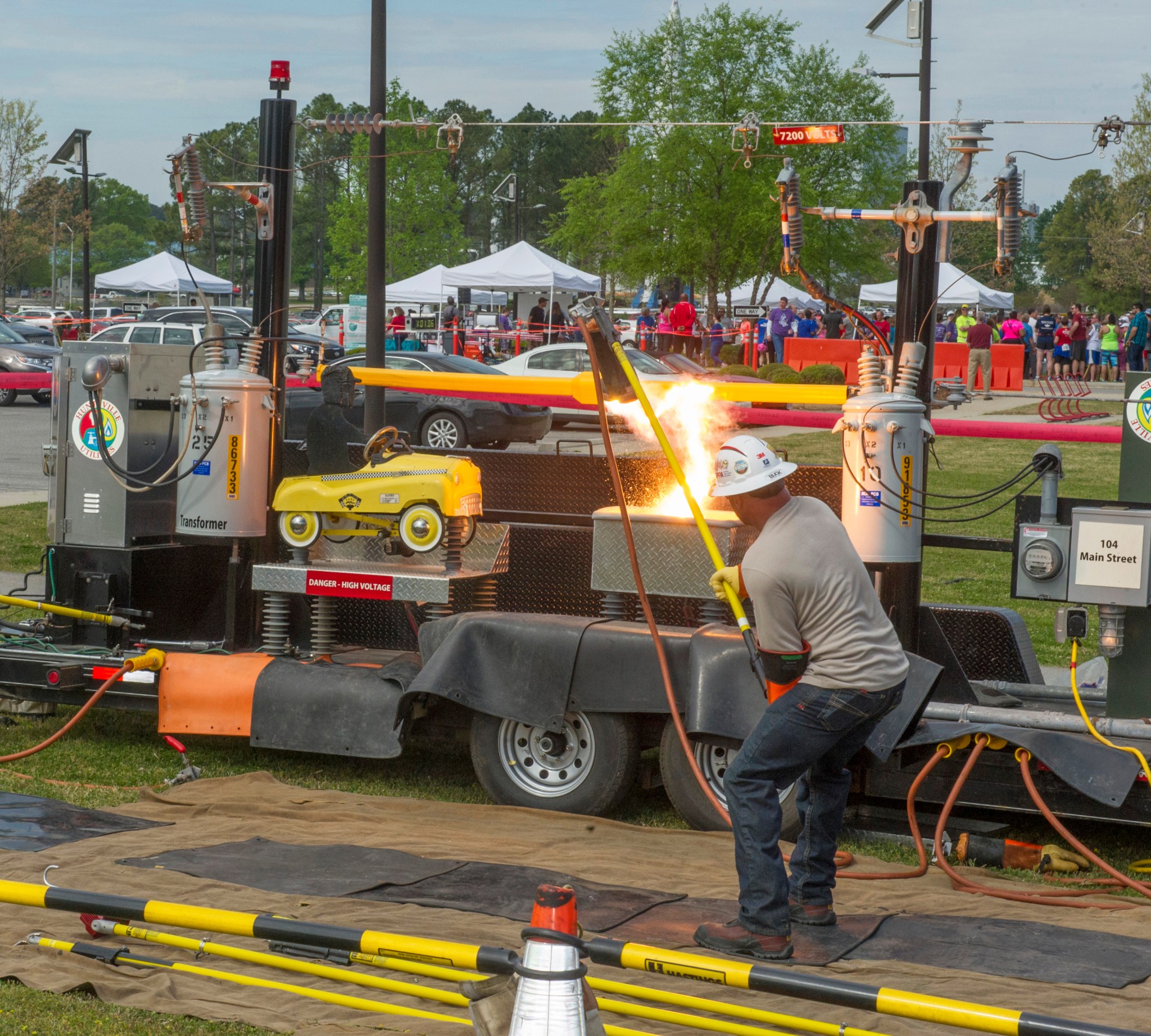 A Huntsville Utilities worker demonstrates why it’s important to avoid power lines.