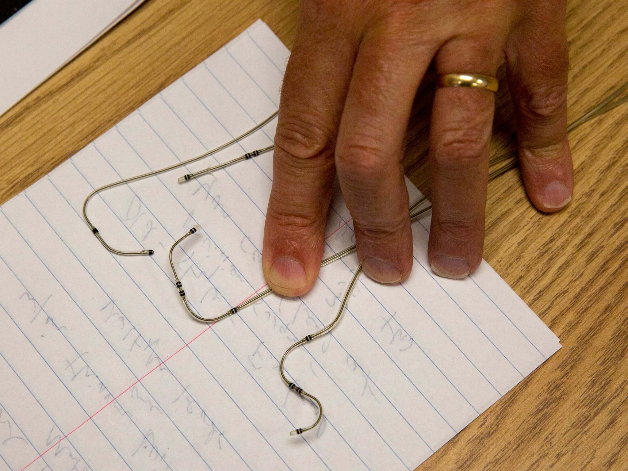 Robert Bryant displays examples of wires made with LaRC-SI.