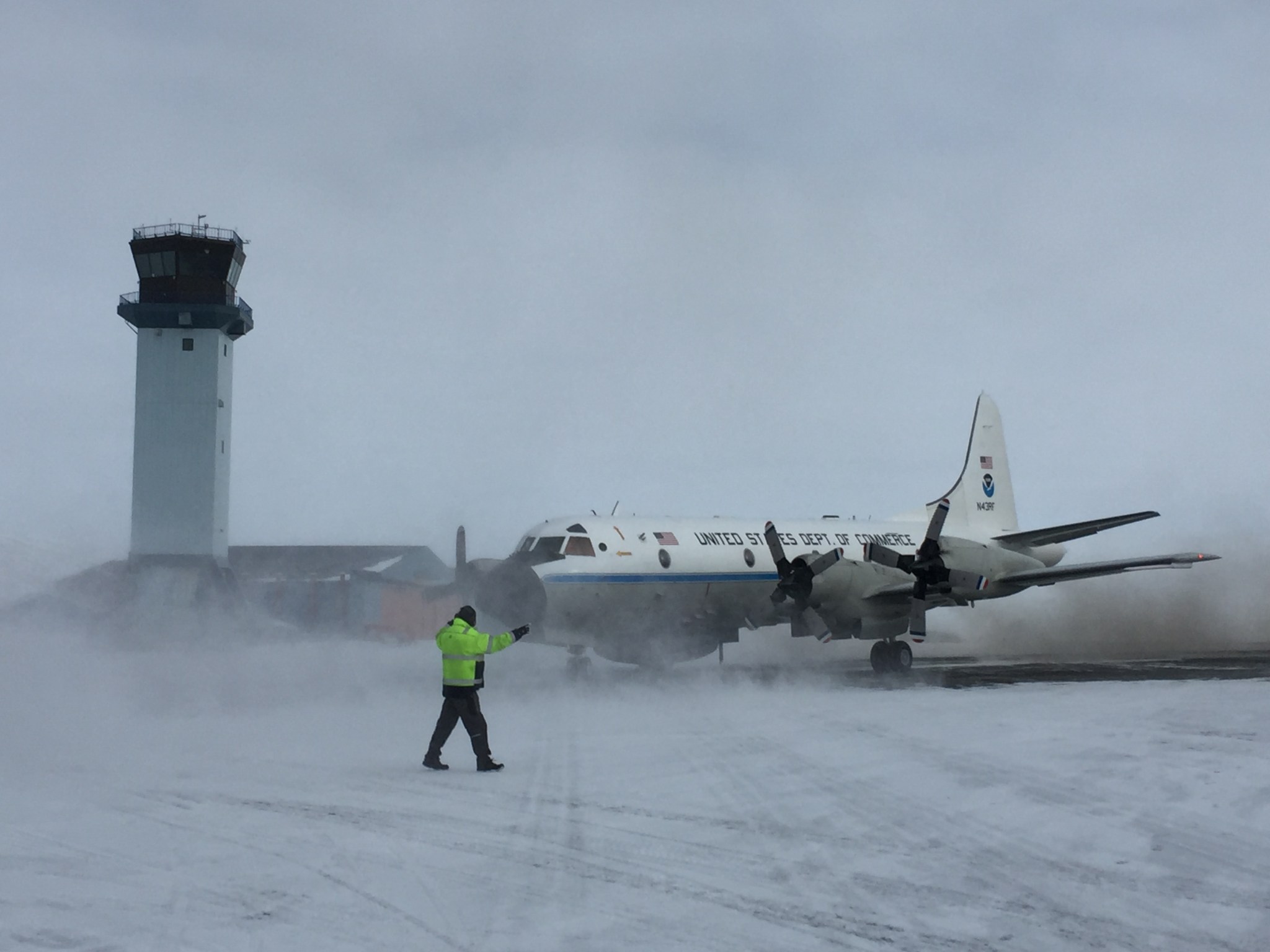 Plane taxis near tower on ice runway