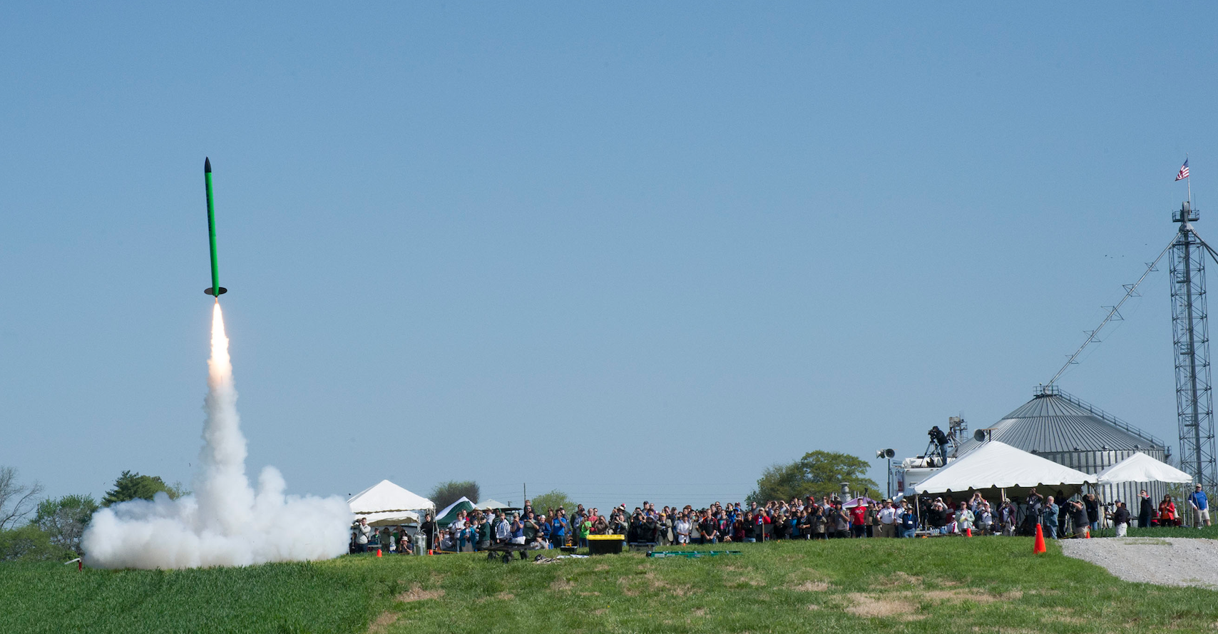 Crowds watch the liftoff of a student-built rocket during the 2015 NASA Student Launch event. 