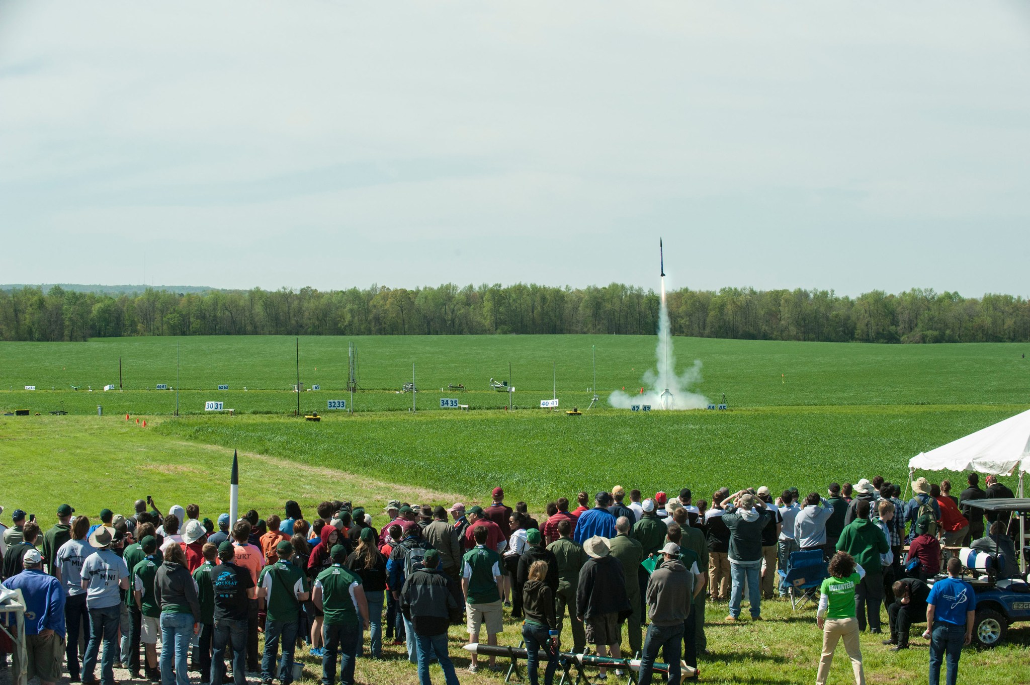Crowds watch the liftoff of a student-built rocket during the 2015 NASA Student Launch event. 