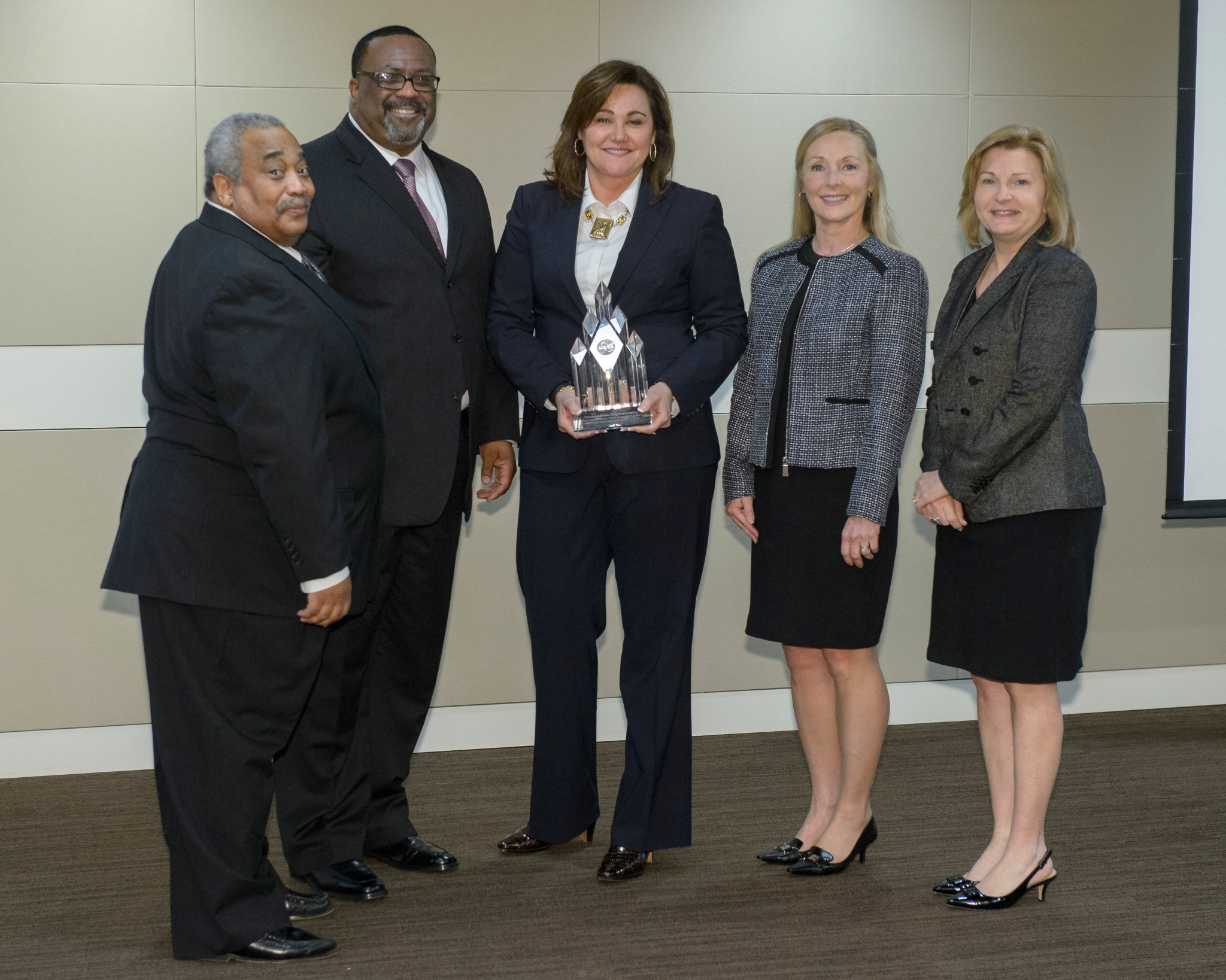 Garen Gero, center, business development manager at Dynetics, is presented NASA’s Small Business Prime Contractor of the Year.