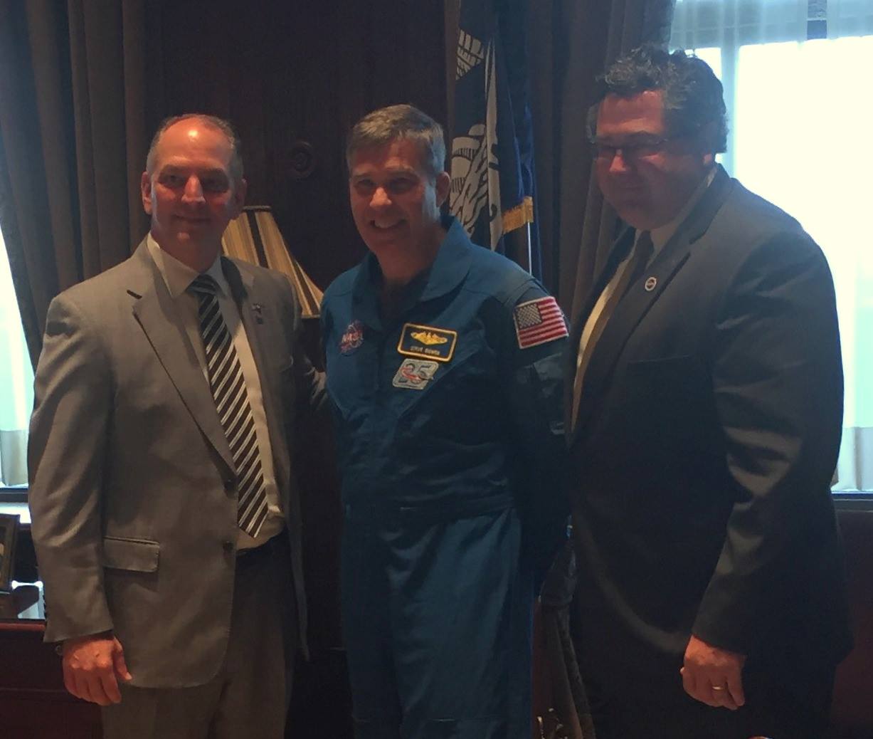 Louisiana Gov. John Bel Edwards, left, welcomes Marshall Center Director Todd May, right, and astronaut Steve Bowen on NASA Day 