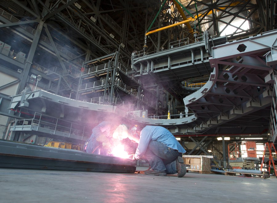 Workers inside the VAB prepare for installation of Platform H North inside High Bay 3