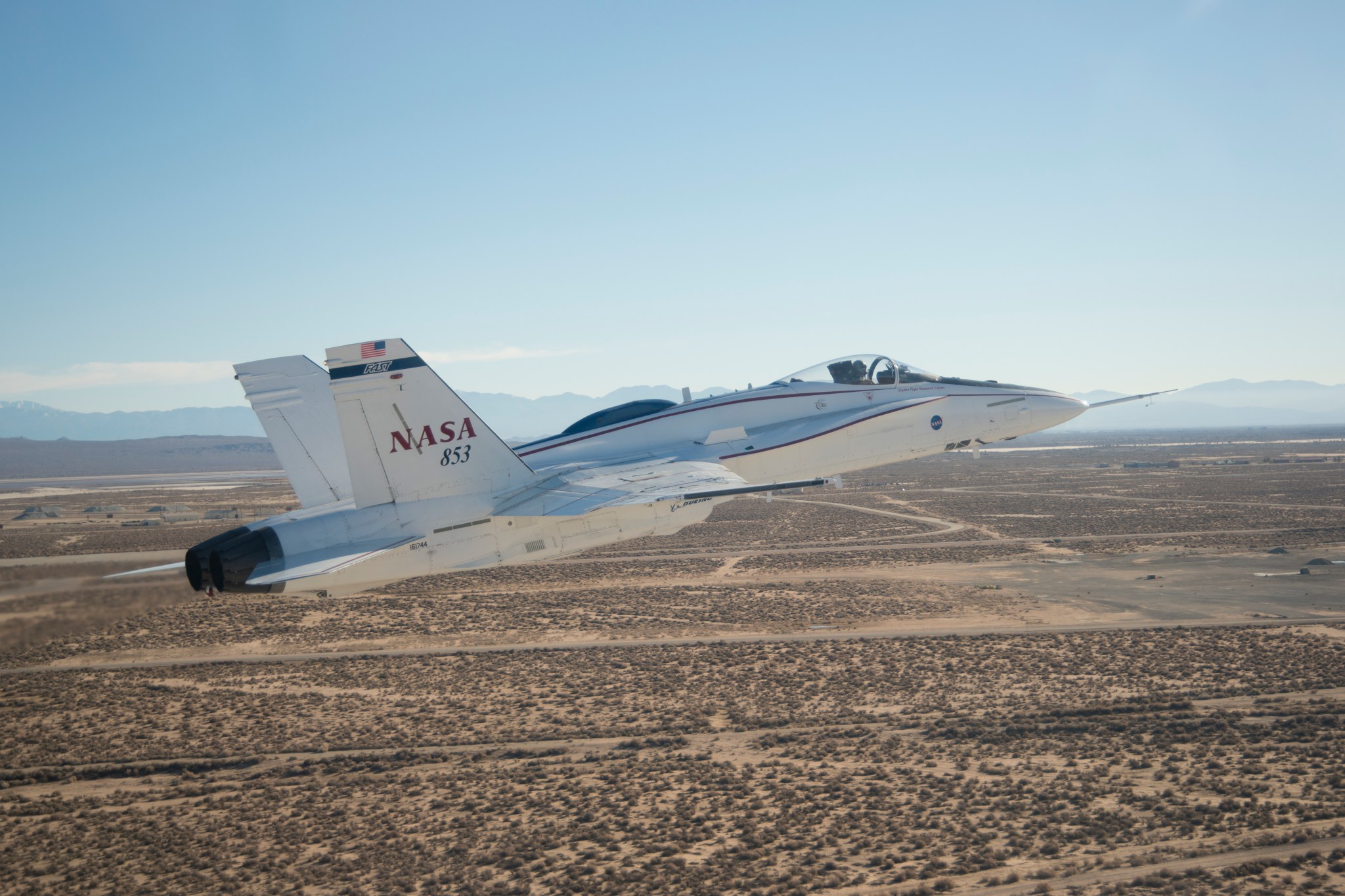 F/A-18 A in flight over land.