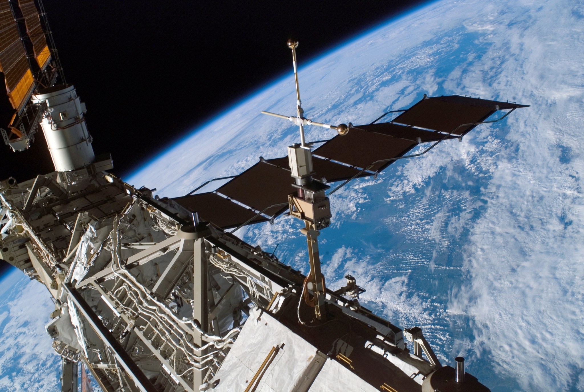 The Floating Potential Measurement Unit, seen at right mounted to a truss on the International Space Station.