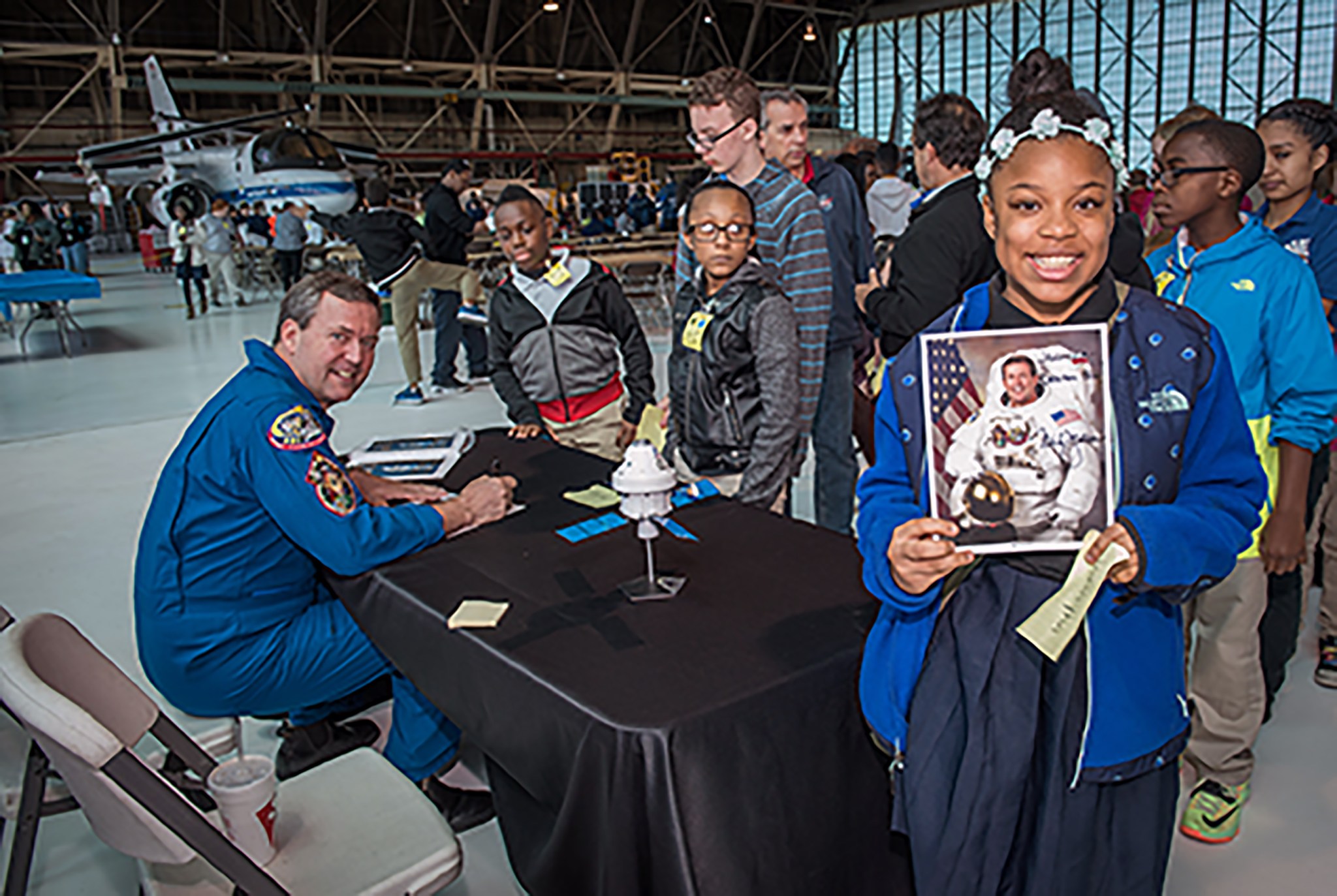 Retired NASA astronaut and spacewalker Mike Foreman signed autographs for students at the 2015 National Lab Day.