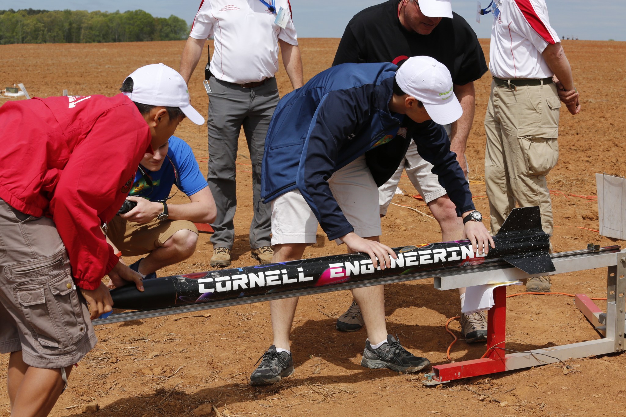 This year’s third-place Student Launch winners from Cornell University of Ithaca, New York, load their rocket on a launch rail.