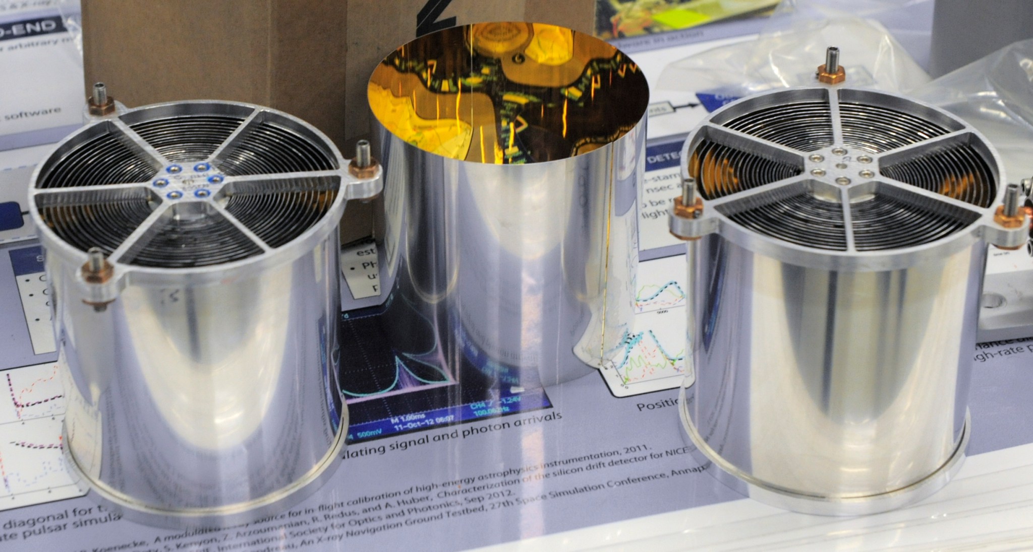 Cylindrical mirrors on table in cleanroom.