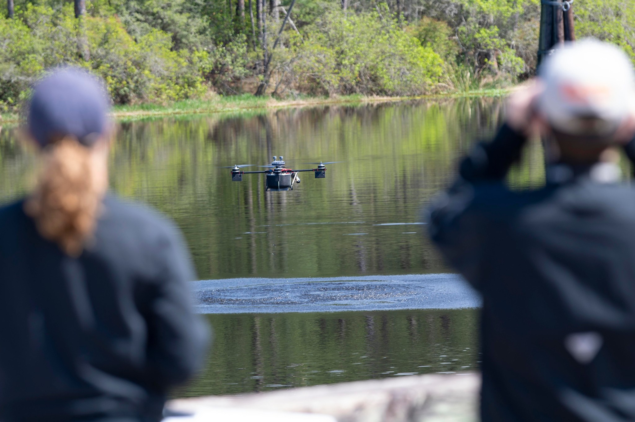 a drone flying low over a body of water