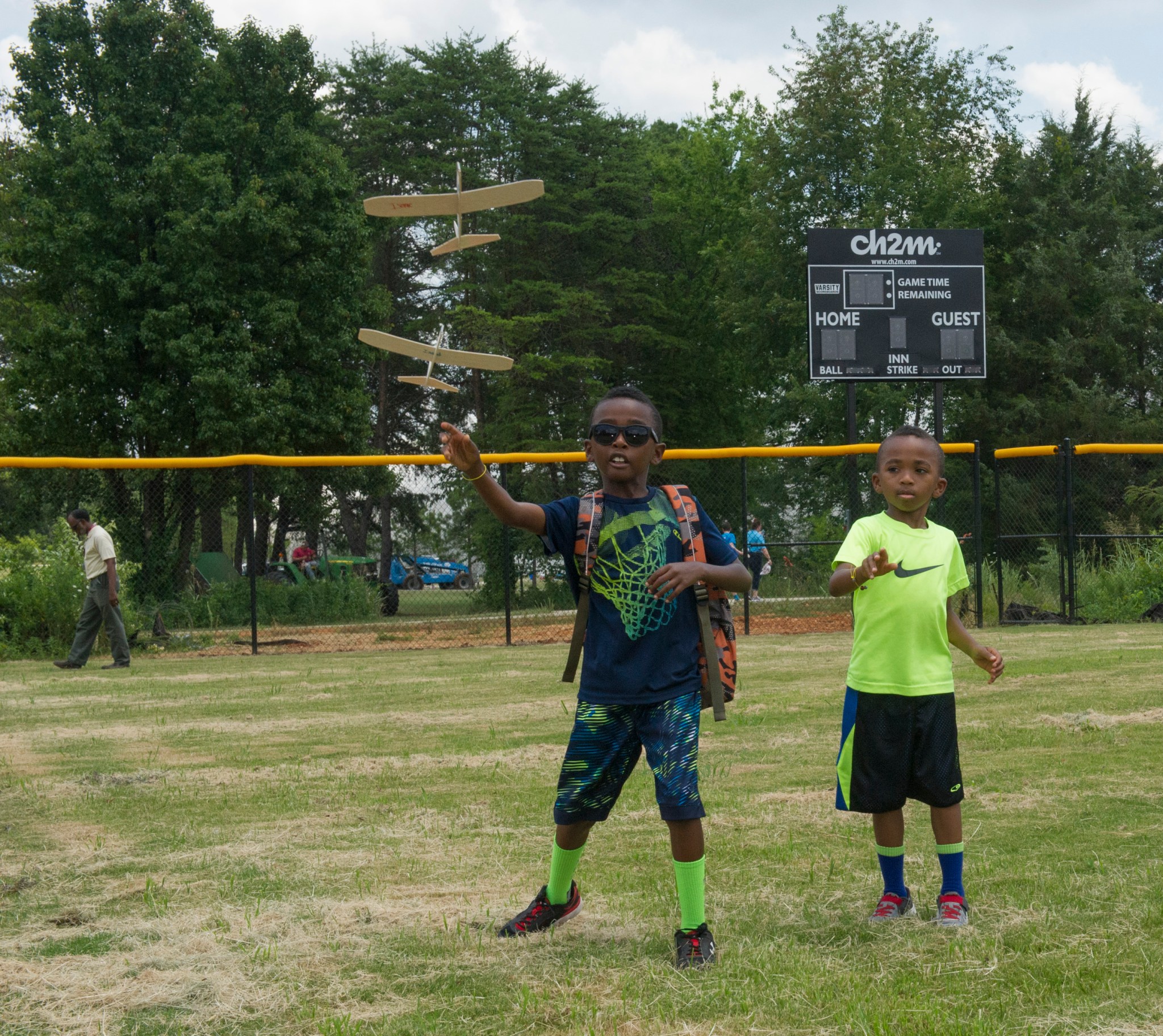Isaiah Cylar, left, and his brother Isaac, sons of Rosalind Cylar, test their gliders during “Take Our Children to Work Day.”