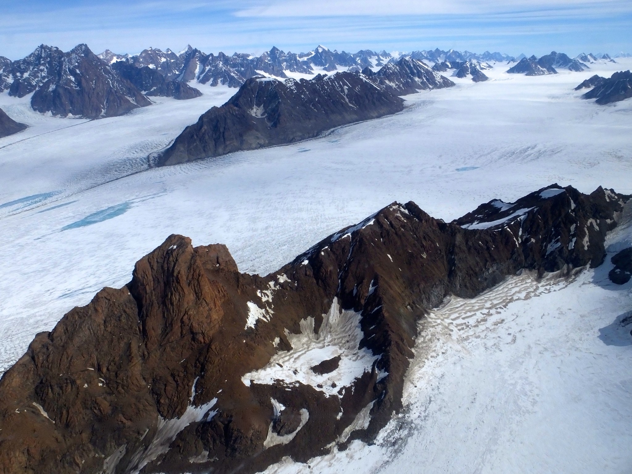 rocky ridge knifing between glaciers