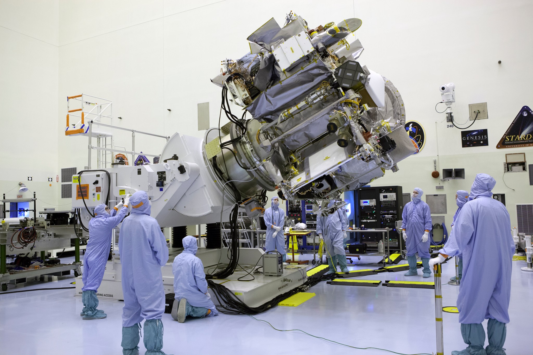 Engineers position the OSIRIS-REx spacecraft during processing at NASA's Kennedy Space Center in Florida.