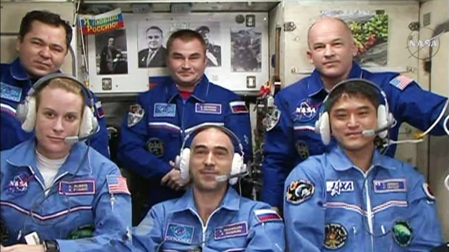 The six-member Expedition 48 crew join each other for well wishes and congratulations from family, friends and mission officials. In front, from left are the new crew members Kate Rubins, Anatoly Ivanishin and Takuya Onishi. In the back row are Flight ENgineers Oleg Skripochka and Alexey Ovchinin and Commander Jeff Williams. Credit: NASA TV