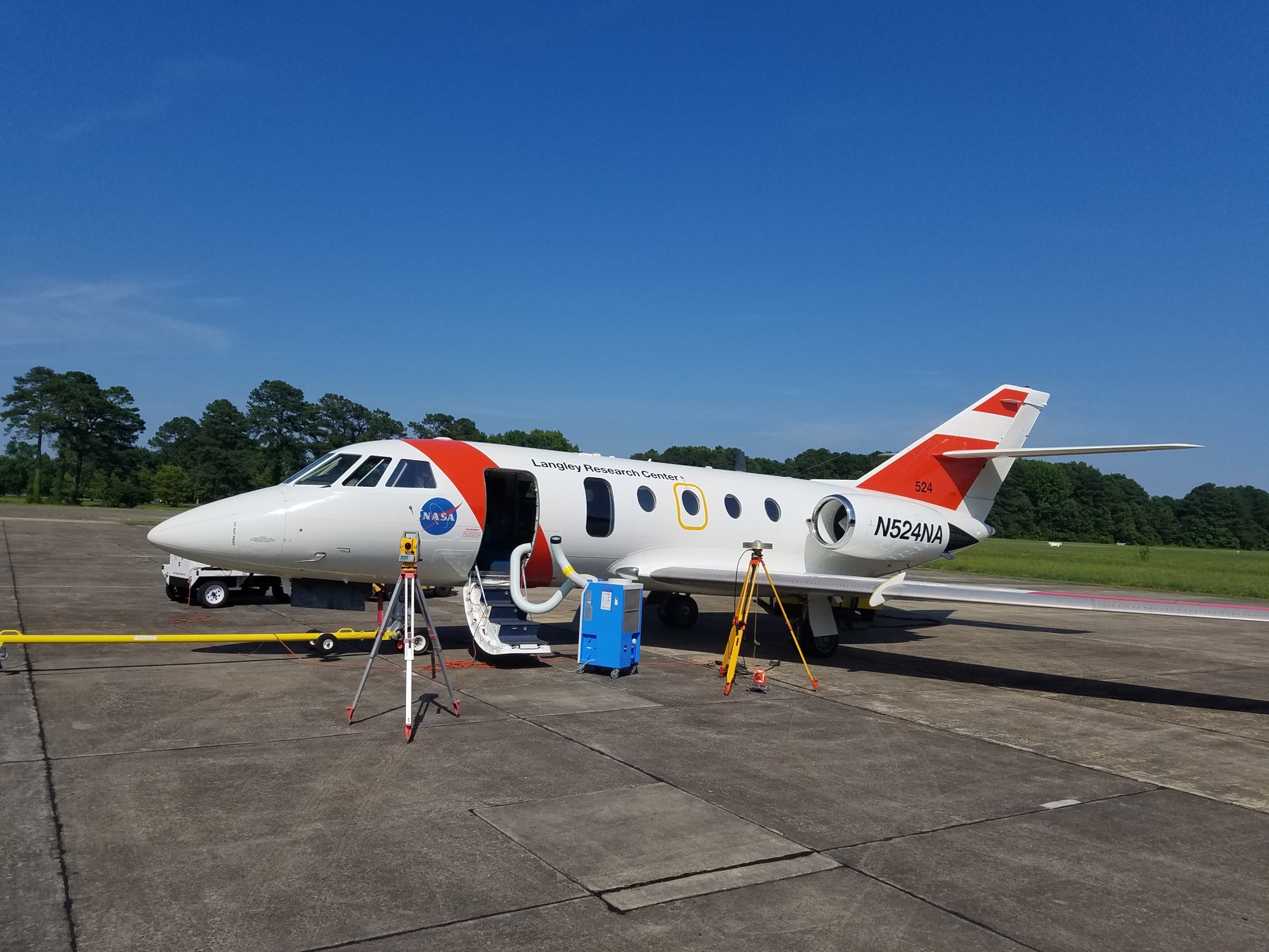 Small aircraft on runway with door open