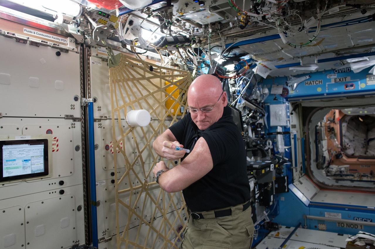 Scott Kelly gives himself a flu shot during his one-year mission aboard the International Space Station. 