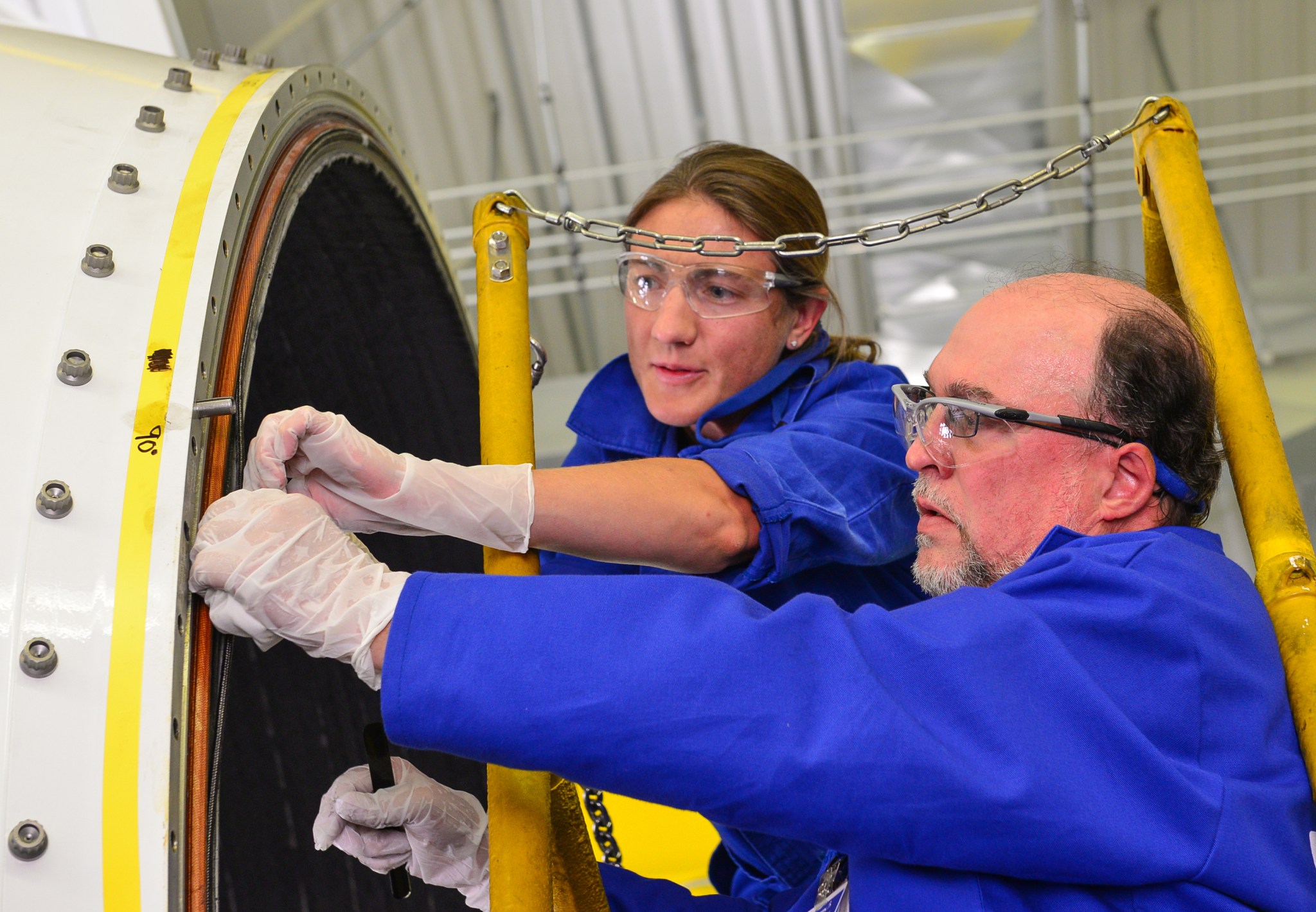 Orbital ATK engineers begin disassembling the booster aft exit cone.