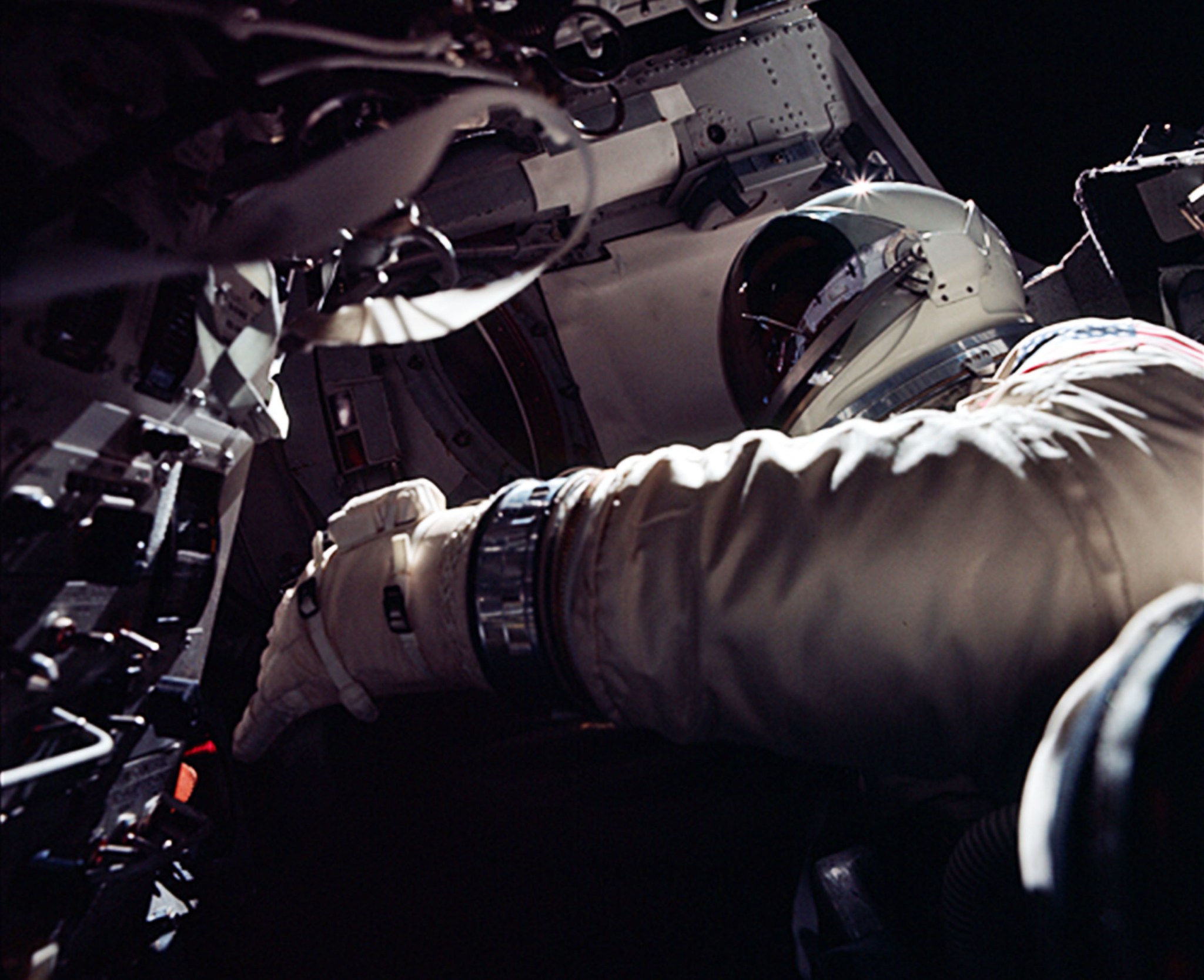 Dick Gordon stands in the open spacecraft hatch