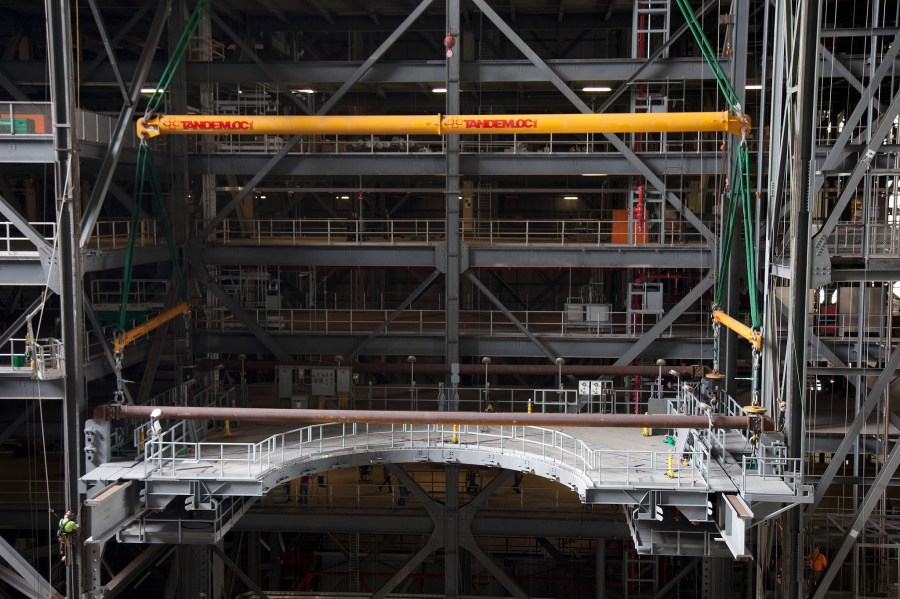 Work Platform E South is lifted and installed in High Bay 3 in the Vehicle Assembly Building.