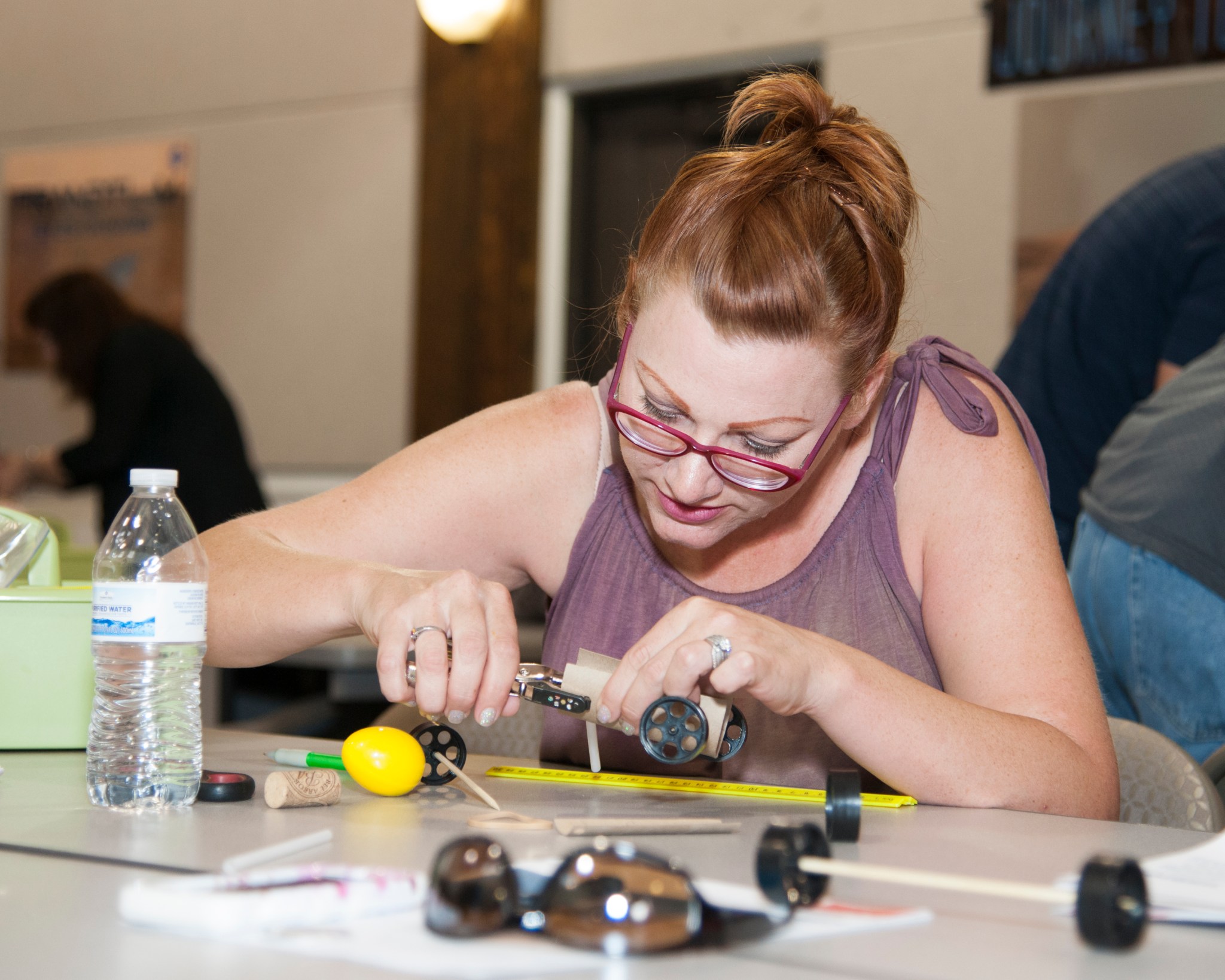 An educator builds a Mars rover at the Journey to MARS workshop.